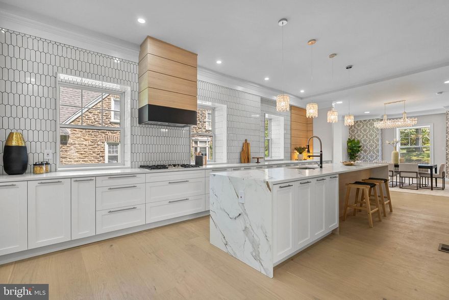 319 Pelham Road is a stunning estate where modern blends with history in this full restoration. This 7 bedroom, 6.5 bath residence offers 6,865 square feet of living space in the heart of Mount Airy. Fully rehabbed with meticulous attention to detail, this home combines the original architectural charm with new modern elements. The curb appeal is vast with a gorgeous wraparound porch which leads into sun-filled interiors that highlight the home’s thoughtful design. Expansive living and dining areas flow seamlessly, showcasing luxury finishes throughout while honoring the property’s original character. The chef’s kitchen features premium appliances and custom cabinetry with amazing storage. Upstairs, generously sized bedrooms and spa-inspired bathrooms provide comfort and privacy for the whole household. The primary suite is a true retreat, featuring abundant natural light, a beautifully appointed bath, and a HUGE walk-in closet designed for both style and functionality. Additional highlights include a large rear yard, ideal for outdoor gatherings, gardening, or play, as well as flexible living spaces that can serve as home offices or guest quarters. Perfectly situated in the desirable Mount Airy neighborhood, this home blends historic charm with modern conveniences in a vibrant community setting. Taxes and square footage is the responsibility of the buyer to have verified independently.