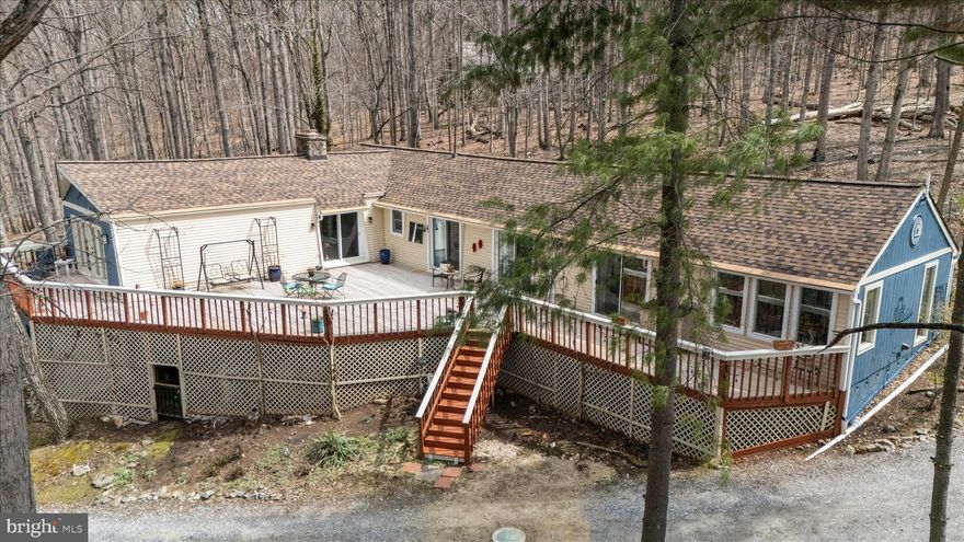 Tranquil peaceful setting to get away from it all!  Surrounded by nature and trees with 5.19 acres and 2240 sq. ft. of luxury living space, at the end of the lane.  Nature lovers' paradise!  Abundance of windows throughout the home, cathedral ceilings and skylights.    This one-floor living 3-bedroom 2 bath contemporary ranch gleams with character and unique style.  Double-sided stone fireplace in the kitchen and great room (20x32) with cathedral ceiling, wood beams, and pine plank wood floors.  The kitchen is full of charm with the woodstove insert and stone work of the fireplace, and the built in microwave hearth and wall oven, stove top, dishwasher, new refrigerator, new stainless steel deep double bow sink, oversized island with storage underneath, plenty of cabinet space, and a walk-in pantry and laundry room.  The large primary bedroom has oversized closets and shelving for extra storage.  The primary bedroom leads into a large primary bath with a double sink, shower, and raised ceiling.  Off of the primary bedroom is a sitting area for enjoying quiet moments surrounded by nature.  The primary bedroom and all of the bedrooms have a sliding glass door that leads to the oversized deck, for quick access to experience all of the outdoor wonder.  The primary bath was recently redone. The second and third bedrooms have ample space. The large deck is perfect for entertaining, dining or quiet evenings.  The deck was recently resurfaced.  The yard also has a firepit for roasting marsh mellows and keeping warm on cool evenings. The property has a  fully functional chicken coop ready for use! Homesteaders dream! The roof was replaced in 2024.  Many upgrades.  This home is ready to move in,  just add your personal touch!  A must see!  One of a kind!  Hurry won't last long!