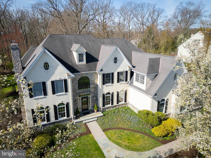 PRICE IMPROVEMENT in one of one of Lower Gwynedd Township's most sought-after communities! Nestled on a serene 3/4-acre lot surrounded by woods and specimen trees, this exquisite Philomeno & Salamone home offers a captivating blend of sophistication and comfort. With quick access to the township's renowned walking trails and mere minutes from shopping, highways, and the Gwynedd Valley Train Station, convenience meets exclusivity at this remarkable property. Spanning 6200 square feet, this meticulously designed residence boasts a bright and thoughtful floorplan, including a 3-car garage that is also host to its very own charging station and an unfinished basement awaits your personal touch—ideal for a home gym, wine cellar, or custom entertainment space. Step inside to discover the grandeur of the dramatic two-story foyer, adorned with natural hardwood floors and a recessed staircase. Flanking this entrance are a sunken formal living room with a wood-burning fireplace and an elegant dining room, setting the stage for memorable gatherings. The heart of this home is undoubtedly the impressive two-story family room, featuring a wall of windows that flood the space with natural light and offer seamless access to the enchanting rear yard—a true oasis for relaxation. The gourmet kitchen showcases a neutral palette, high-end appliances, and a center island, complemented by a cozy breakfast room—a perfect spot to start your day. Working remotely? Enjoy the custom-built home office flooded with southern exposure, ideal for enhancing productivity in a serene setting. Additional highlights on this level include a large mudroom and two half baths. Upstairs, retreat to the expansive owner's suite complete with a sitting room (perfect for a home office or additional closet space), and a luxurious bath featuring a soaking tub, separate vanities, and a stall shower—all while basking in the serene views of the private wooded surroundings. The second floor also offers two generously sized bedrooms sharing an adjoining bath AND an additional en-suite with a stall shower—ensuring comfort and privacy for family and guests alike. Venture to the third floor, currently a versatile home gym but easily convertible into a fifth bedroom or personalized space to suit your lifestyle given the convenience of water and sewer lines already in place. Located within the top-ranked Wissahickon School District and the tranquil Lower Gwynedd Township, this exceptional property embodies a lifestyle of distinction and convenience. Don't miss the opportunity to make this extraordinary residence your own—call today to schedule your private showing and discover why this home is the epitome of luxury living in Lower Gwynedd Township.