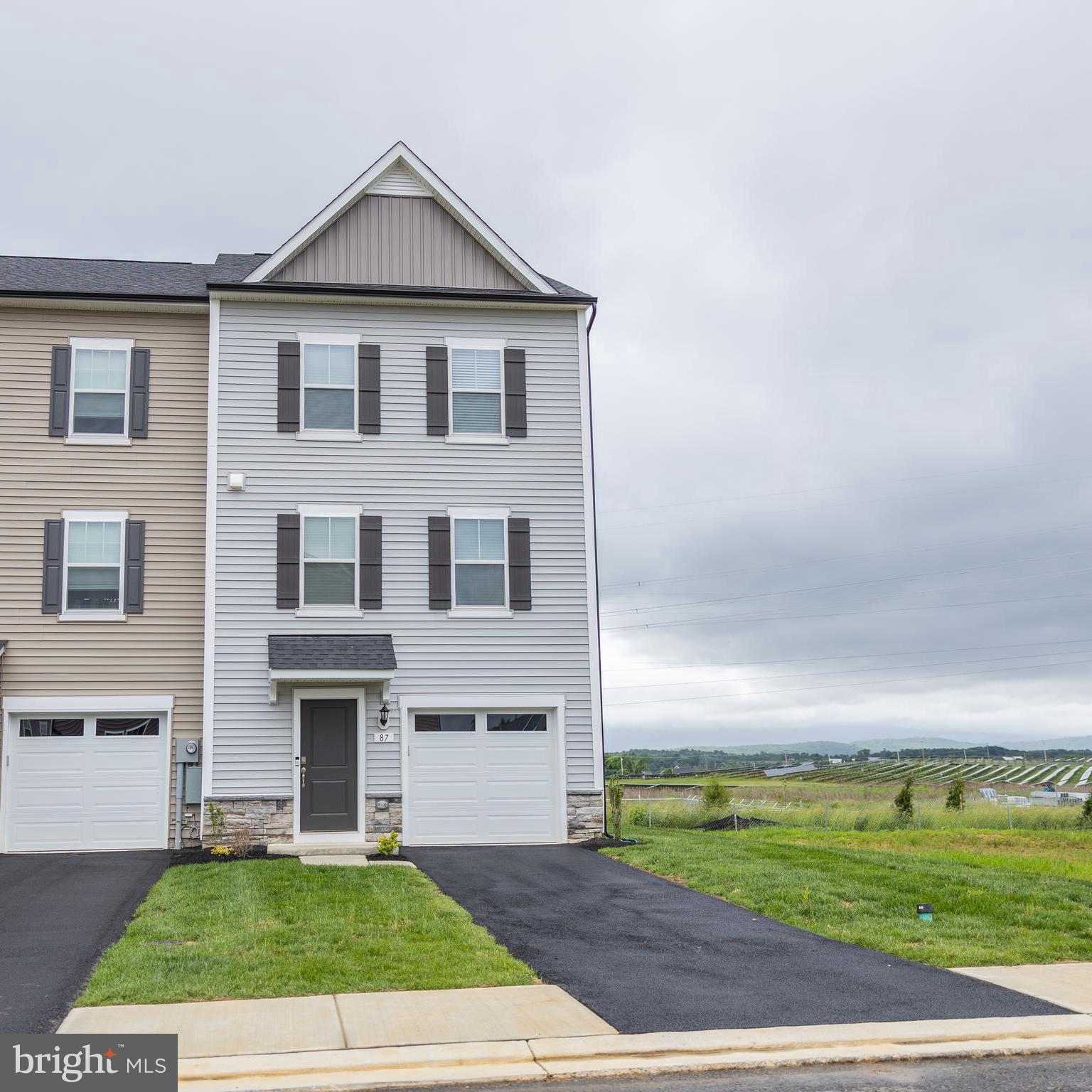 Welcome to this brand NEW stunning end-unit townhome located in the King's Crossing community, featuring three finished levels. Each space in the home is filled with ample natural light, creating a bright and airy atmosphere. As you enter, you'll instantly see the durable LVP flooring that guides you to the spacious recreational room, which conveniently features a full bathroom. As you make you way upstairs, the LVP flooring continues to the second level, where the open concept layout makes entertaining a breeze. The kitchen is equipped with stainless steel appliances and stylish quartz countertops, along with a cozy half bath nearby. Step out onto the private deck, perfect for relaxation or summer barbecues. Ascending to the third level, the primary bedroom boasts a spacious walk-in closet, while the bathroom features a double vanity and tile flooring. This level also includes two additional bedrooms and another full bathroom, with laundry conveniently located nearby. Located in the desirable Charles Town, WV area, you'll be just minutes away from shopping, dining, and recreational activities, with convenient access to major commuter routes. Don't miss out on this wonderful opportunity to rent this lovely home!