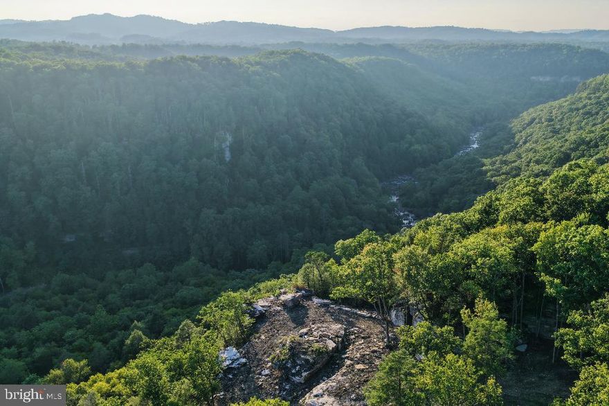 Discover 44 unrestricted acres of rare Appalachian beauty-- a one-of-a-kind property boasting 1,355' of gushing Class V Meadow River frontage, a private waterfall, and a powerful stream flowing down to the river.  Perched above it all, you'll find dramatic cliff-top gorge views that rival the best of the national park. 

This secluded parcel is found at the end of Ridge Run road, with zero road noise- you'll only hear the soothing roar of the river and waterfall. 

Prime Location: Just 15mins from Fayetteville and the New River Gorge National Park, and 15mins to Summersville Lake State Park.  Within 30mins to five different state parks- this property sits in the heart of West Virginia's outdoor playground.  Truly a recreational mecca for whitewater, climbing, hiking, biking, and more

Feels like a world of its own, yet with power and city water nearby. Possible seller financing.