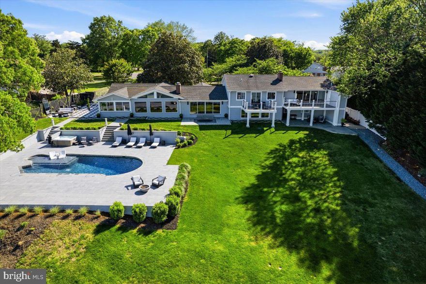 BELLA VISTA | Turnkey Waterfront Estate | Patuxent River | 90 Miles from DC —Arrive with your suitcase.  Everything else is already here
 
Just your waterfront life — ready on Day One.
Ninety miles from Washington DC and Northern Virginia and no Bay Bridge traffic. 

 Bella Vista on the Patuxent River is the waterfront escape DC Metro buyers have been searching for — without the Bay Bridge bottleneck. Located in Esperanza Farms with direct river access to the Chesapeake Bay, this fully renovated five-bedroom, five-and-a-half-bath estate has been designed and curated for the way waterfront life is actually lived. For the buyer seeking a truly effortless transition, an exceptional furnishings package is available for separate negotiation — encompassing everything from original artwork and designer furniture to kayaks, canoes, a paddleboard, yard games, entertaining supplies, extra tables and linens, and every piece of equipment that makes a waterfront weekend unforgettable. Arrive. Unpack. Start living.

With a proven 5-star short-term rental history, Bella Vista is both a premier personal retreat and a high-performing income-producing asset — rare at this level of finish.
Thoughtfully reimagined with a complete interior renovation in 2023 and an exterior transformation in 2024, the multilevel home offers a fully accessible main level — ideal for multigenerational living, aging in place, or welcoming guests of all abilities. The main-level primary suite features a zero-threshold shower, designer grab bars, and elevated design that makes accessibility feel luxurious.
At the heart of the home, a chef's kitchen with premium appliances and a gas fireplace flows into a welcoming living room anchored by its own gas fireplace. Four additional spa-inspired bedroom suites are distributed throughout the home — waterfront rooms with automatic remote-control shades, and a private suite complete with fireplace and a coffee bar with sink and beverage refrigerator. A light-filled all-season sunroom, private gym with sauna, custom entertainer's closet, and an exceptional laundry room featuring two washers, two dryers, and a marble dog shower complete the interior picture.
The custom entertainer's closet and garage beach-day rinse station signal a home designed to be truly lived in.
Outside, Bella Vista unfolds as a private waterfront resort: a heated saltwater pool with elevated hot tub, two exterior gas firepits, a wood-burning waterside fireplace, and expansive patios built for golden-hour entertaining. A private pier with Jet Ski lift provides direct access to the Patuxent River — kayak, canoe, and fish from your own backyard, with the Chesapeake Bay just beyond.
Bella Vista is not just a home. It is a refined, operational waterfront retreat — designed to be lived fully, shared generously, or performing as an asset from the very first weekend.