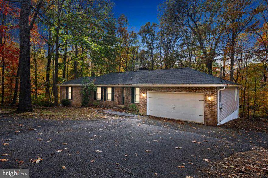 Welcome to 315 Lower Clubhouse Dr. in Harpers Ferry — a fully renovated, move-in-ready brick rancher that brings modern farmhouse warmth and all the big-ticket updates you want already done. This home has been overhauled from the ground up, including a brand-new roof and gutters, a fully encapsulated crawl space with a commercial-grade dehumidifier, new insulation, and an all-new HVAC system with new ductwork. Inside, you’ll find fresh LVP flooring, updated recessed lighting, and a comfortable family room anchored by a wood-burning fireplace. The kitchen delivers serious “wow” factor with quartz counters, a bold 7-ft navy island, new soft-close cabinetry, ceramic tile backsplash, and all-new stainless steel appliances. Both bathrooms have been completely redesigned with modern finishes — including a luxury walk-in tile shower with frameless glass in the primary suite. Every bedroom has updated lighting and new ceiling fans, and even the front door, deck door, and garage entry door are brand new. Step outside to a resurfaced approx. 36’x12’ deck with new railing, plus a spacious 2-car garage and storage shed. With no HOA, low taxes, and quick access to MD and VA, you’re minutes from Mountain Lake Club & Beach, River Country Store, Shannondale Springs Trails, Mount Mission Park, and historic Downtown Harpers Ferry. This is the turn-key home buyers wait for. Come and take a look!