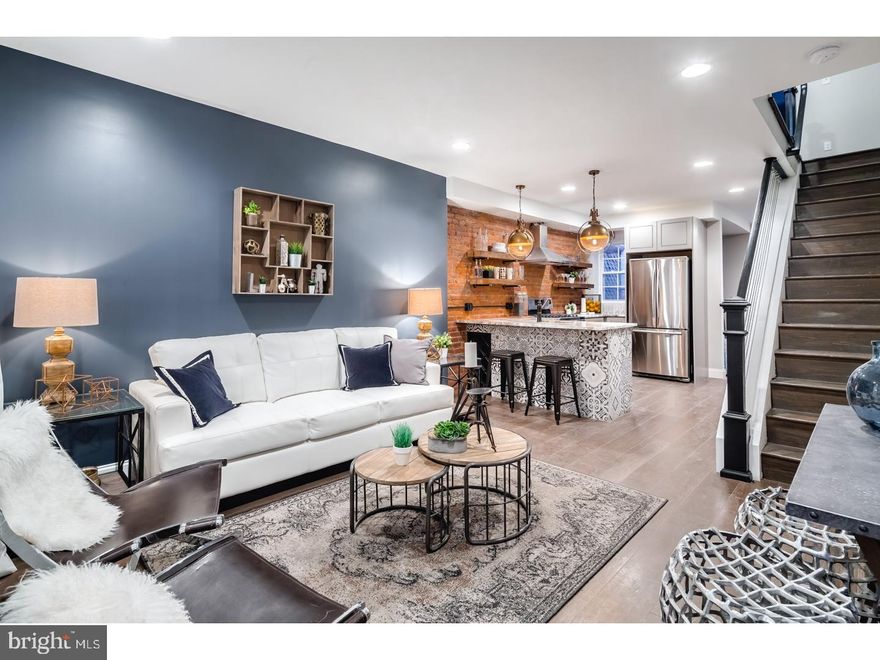 Step inside this custom, professionally designed, home in incredibly walkable Fishtown.  Enter into a main floor open-concept with living room, kitchen, and dining space. The Kitchen features an L shaped quartz countertop, Samsung stainless steel appliances, custom reclaimed joist shelving, shaker style "slow close" drawers & cabinets and plenty of natural light.  The front of the countertop peninsula is wrapped with designer tiles and includes a custom built wine rack. Exposed brick and designer lighting are showcased throughout the home.  Pass through the kitchen into the dining space with office nook and pantry.  Exit the rear door to a fenced-in backyard space ready for your outdoor festivities.  The 2nd floor of this home contains 2 bedrooms and 2 full custom bathrooms.  The master bedroom features built in electric fireplace as well as two closets.  Guest bedroom comfortably accommodates a queen size bed and nightstands.  This home features a master bathroom with walk in shower, guest bathroom with combined tub/shower, and one of a kind designer vanities and tile in both.  This home has been completely redone from top to bottom.  Brand new electrical, plumbing, Hot Water Heater, HVAC (with Nest thermostat), exterior facade, windows, and featuring 7" wide plank hand-scraped floors throughout.  Brand new roof with warranty.  Not a detail has been missed.    Walk to many of Fishtowns hottest establishments such as Medusa Pizzeria, Coffee House Too, Loco Pez and many more.  Street parking is readily available, easy access to 95.   Custom Philly Homes was recently featured in the Philadelphia Inquirer, Philly mag, and Curbed for their incredible custom design & development.  This house is fully staged for your viewing pleasure and furniture is available for purchase through Lux-Living.