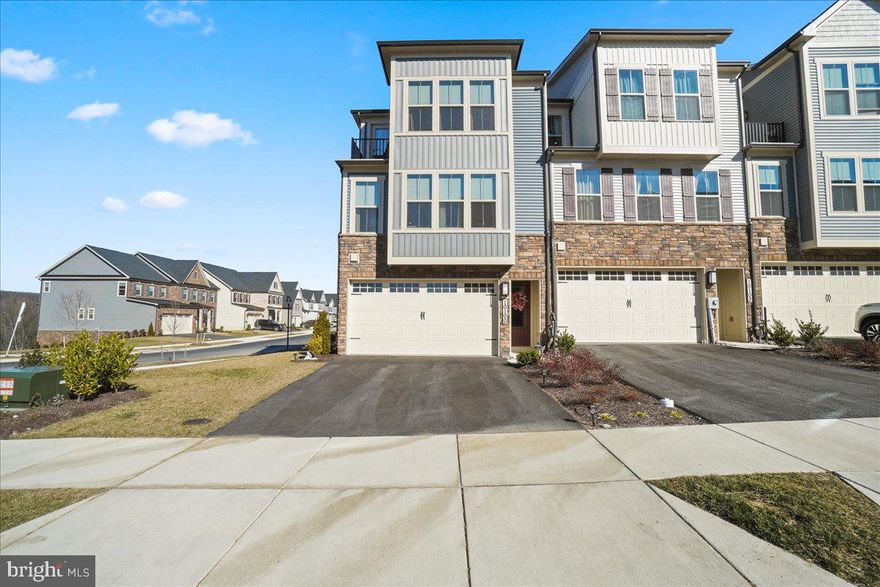 The Beauty Of BLUEGILL! This Limited Offering of 8 Month Young New Construction is Pristine in Every Way!! Own this stunning 3-story End Unit Town Home in the desirable Lake Linganore Town Center! There is no need to wait for a new build when you can move into this brand-new home, built in 2023.  The versatile family room can easily be transformed into a fourth bedroom. You are featuring plush carpet,  rough-in for ceiling fan, cable and outlet for hanging a TV, and a touchpad for the alarm system with a front door camera. Step up one level to the main living level and be greeted by an expansive covered porch outdoor living area room extension with a beautiful stone wall and built-in fireplace.
The fireplace even has LED lights that can change colors! Hang your TV on the mantel using the cable and electric outlet provided. Enjoy extra privacy with a shade.  This home kitchen Boasts a lish backsplash, stainless refrigerator and appliances, and additional LED lights extending into the spacious, bright, sunny family room. The corner unit offers extra windows and other room bump-outs. Plus, enjoy the convenience of a "Smart Home."  On the top floor, you'll find the floor. Ng carried into the closet and laundry area for a seamless look. The bedrooms have plush neutral carpet and rough-in for ceiling fans. The primary bedroom is complimented with additional  LED lighting s and power source/cable connections.   One of the selling features of this home is its premium lot location. As an end unit, you enjoy the grassy easement across the street that offers unparalleled views of undisturbed nature. Relax on your top-floor balcony while enjoying your morning coffee or cool evenings! Take advantage of this incredible opportunity to own a modern townhome with all these fantastic features! This community benefits from the long list of amenities Lake Linganore offers!  Minutes to central commuter locations and amenities of charming New Market, Frederick, and proximity to Baltimore, Virginia, and Washington, DC.