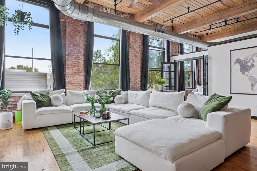 Welcome to 1524 N Hancock Street #402, a stunning residence nestled in the vibrant Olde Kensington neighborhood of Philadelphia. This captivating 2-bedroom, 1.5-bathroom home exudes character from every corner. With soaring 14-foot ceilings, exposed wood beams, ductwork, and striking exposed brick, this home is brimming with character. Step inside and be greeted by the lofty exposed ceilings and charming brick walls that define the space. Oversized windows illuminate the open layout, highlighting the rich hardwood flooring throughout.

The chef’s kitchen is a modern masterpiece, boasting sleek teak cabinetry, a spacious central island with seating, and top-of-the-line stainless steel appliances. The bright and airy living and dining areas offer a view framed by brick walls and sizable windows, ensuring a flood of natural light. French doors lead to a guest bedroom featuring ample closet space, while the primary suite impresses with generous closets and a luxurious en-suite bathroom adorned with ceramic tile, a soaking tub, separate stall shower, and dual vanity. For added convenience, there's a powder room and a laundry room with pantry storage.

Among the standout features of this unit is the convenience of private assigned parking on the grounds, a true luxury in the city. 

Located in Philly's prime neighborhood, this home is just a few steps away from all Fishtown fun. Recently named "America's Hottest New Neighborhood" by Forbes, Fishtown is brimming with top-rated restaurants, lively entertainment spots, local boutiques, and charming coffee shops. With so much to explore on foot, you'll never run out of things to do. Plus, if you need to travel further, nearby SEPTA bus lines and the "El" Market-Frankford line provide quick access to anywhere in the city and surrounding suburbs. There’s also easy access to I-95 and South Jersey, making commuting a breeze.

If you are looking for a unique space, The wow factor, parking, and top location, this is for you.