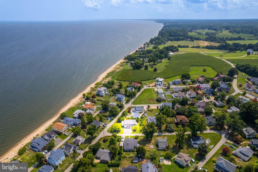 Enjoy Bay Breezes and Building Sandcastles on the Beaches of the Chesapeake Bay Steps From Your New 4 Bedroom, 2 Bathroom,  2255 Finished SF Home at 5117 Knoll Road.      Main Level has a Spacious Kitchen with Granite Counters, Stainless Appliances with Breakfast Bar Open to Living Room and Family/Sunroom Surrounded with Windows.  Entertaining is Easy with Your Spacious Kitchen Open to Living/Family and Sunrooms and then Deck with Views of the Water.   You will Enjoy your Lower Level Rec Room, 2 Nicely Sized Bedrooms, Full Bathroom, Laundry Room and then Access to Your Garage/Workshop with Workbench.   This Very Special Community will Make you Feel as if You are on Vacation---Everyday.  Friends Call it "The Charm of the Chesapeake"  As You See, Home has Been Well Maintained and Only Needs You to Move In !  Renovations Include:  2024- Water Heater and Expansion Tank; 2020-2024-Roof with Architectural Asphalt Shingles; Kitchen Renovation to Include Granite Counters, Stainless Steel Appliances and New Cabinetry; Main Level Bathroom Renovation to Include New Dual Vanity, New Oversized Tiled Shower, New Toilet, Light Fixtures, Accessories and LVP Flooring; Installed New Siding.  Offers will be Submitted to Seller as We Receive; Seller Welcomes Escalation Clauses.