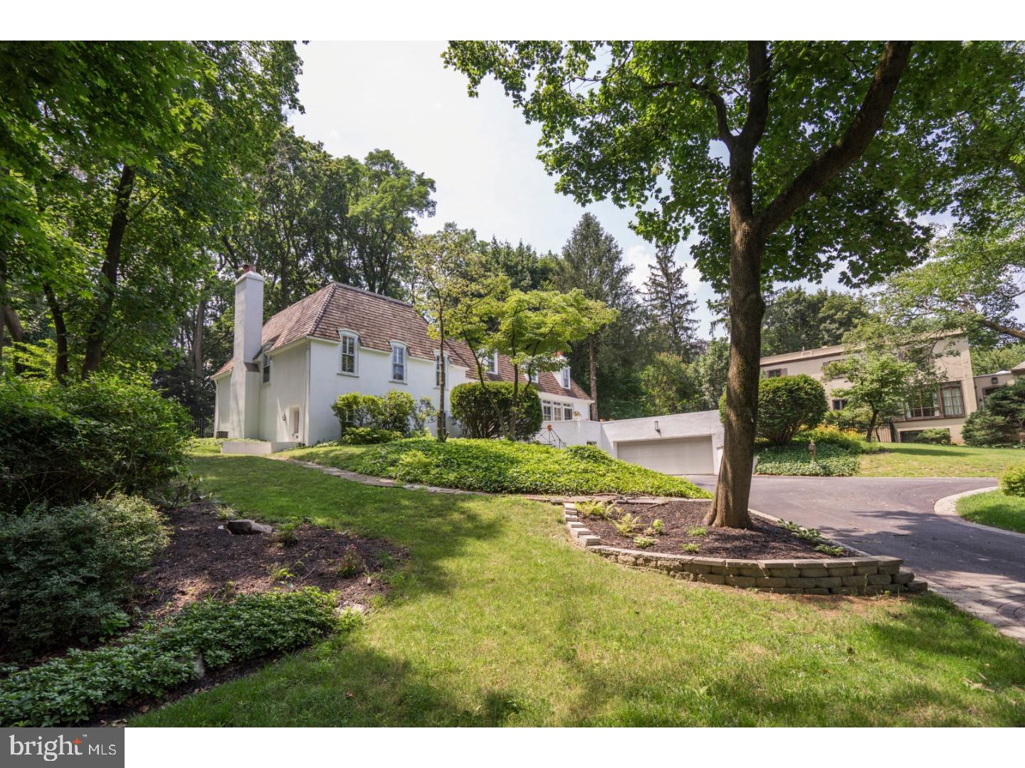 If it's sophistication and natural light you're looking for, your house-hunt ends here on one of the prettiest and centrally located streets in highly desirable Bryn Mawr. This pristine and sophisticated French Colonial delivers a love-at-first-sight impact, with .84 acres of manicured lawns and gardens, stunning split staircase, circular drive and 2-car garage. Inside won't disappoint either by offering all the home features you'd hoped for. The elegant foyer leads to a wonderful open floor plan featuring Brazilian walnut floors, and an abundance of natural light from two walls of windows on each side of the home's first floor. French doors off the living room take you to a smart, new roof top deck. A stunning living room fireplace with marble surround punctuates the space. Your dream white kitchen with soft-close cabinetry, granite, stainless, Subzero, extra prep sink, and a center island was newly installed, and its wall of windows overlook the unique gardens that punctuate the backyard space. Off the kitchen is an open floor plan dining room and family room/den where you can talk to guests, keep an eye on the little ones or convert it to your own literary sanctuary. All three rooms access a slate patio out to a beautiful backyard and gardens. A granite powder room completes this floor. A few steps down you'll find an over-sized, second family room with fireplace, outside access and built in bookcases-the perfect place for games and TV. Laundry, a powder room, and an extra office space is included on this floor. Upstairs you'll find a master bedroom with walk-in closet, luxurious onyx bath with two vessel sinks, and a secondary bedroom with a marble bathroom with double sinks, shower and bath. The top floor leads to two more bedrooms with a full bath outfitted with a unique glass counter top and oversized shower. The 4th bedroom has an oversized, attached playroom or 5th bedroom that easily converts to 'homework central'. Check all the boxes with this home and then add a whole house generator to keep your house running, smart locks so you never find yourself locked out, abundant storage, and gorgeous views of Ashbridge Park with its tennis courts, walking trail, and playground. Lower Merion Schools, walking distance to the train into Center City/NYC. Minutes from Bryn Mawr shops, restaurants, Trader Joes, Whole Foods and Suburban Square. Convenient access to major highways. NOTE: Sale includes land: TAX ID 400000316103.
