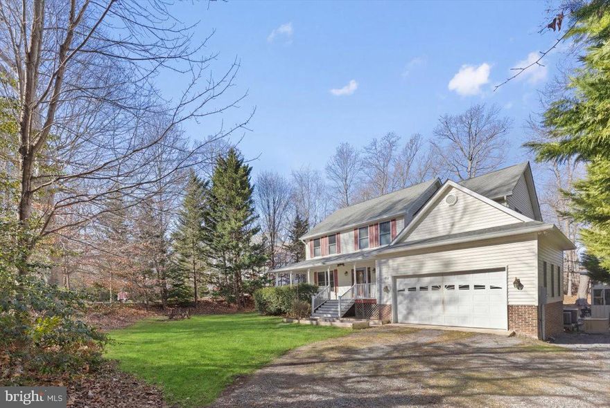 Water-Oriented Living with Your Own Private Pier at 27245 Cat Creek Rd. Here, home truly feels like a getaway every day. Set on a peaceful one-acre lot on Cat Creek just off the Patuxent River, this beautiful Colonial offers direct water access with a private pier in a serene natural setting. While the creek itself is not visible from the home, a scenic walking path leads through the backyard to the water’s edge where the view from the pier opens to the tranquil beauty of Cat Creek—an ideal spot for kayaking, wildlife watching, enjoying peaceful sunsets, or simply relaxing by the water. The outdoor spaces are designed for both entertaining and everyday enjoyment, featuring composite decking, a covered patio, a charming gazebo-style grilling and gathering area, and plenty of yard space to enjoy nature. Multiple storage sheds provide excellent space for tools, outdoor equipment, kayaks, and recreational gear.
This well-maintained home features 4 bedrooms, 2.5 baths, and a two-car front-entry garage with exceptional curb appeal highlighted by an expansive wraparound front porch and striking double-size stairway. The main level offers hardwood floors, a bright foyer, formal living room, dedicated home office, separate dining room, half bath, and interior garage access. The kitchen anchors the rear of the home with stainless steel appliances, tiled flooring, pantry, pot rack, abundant cabinetry, and a built-in desk overlooking the spacious family room with gas fireplace and backyard access. A sunroom just off the main living area is filled with natural light and offers peaceful views of the surrounding landscape.
Upstairs, the primary suite features tray ceilings, blackout blinds, walk-in closet, and an ensuite bath with dual-sink vanity, oversized shower with two shower heads, and private toilet closet. Three additional bedrooms share a full bath with dual vanities, and an upper-level laundry room adds convenience. The unfinished basement is already drywalled and ready for paint and flooring, providing a blank canvas to create a large recreation room, additional family space, bedrooms, media room, home gym, or whatever best suits your needs. Conveniently located with access to Routes 235, 5, and 4, offering a reasonable commute to NAS Patuxent River, Andrews Air Force Base, Joint Base Anacostia-Bolling, and major employment centers including Waldorf, Prince Frederick, Solomons, Lexington Park, and the Washington, DC metro area.