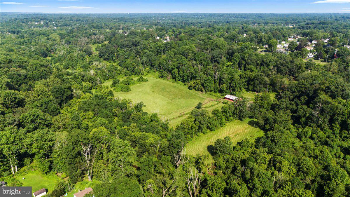 This ideal setting will bring your vision to life! A rare and exceptional opportunity for investors, builders, or visionaries seeking to create something extraordinary in the heart of beautiful Bucks County! Once a thriving thoroughbred breeding farm, this 27.33-acre property still echoes its proud heritage. A weathered barn and the remnants of fencing outline former grazing pastures for these majestic horses - reminders of the land’s rich past and its promise for the future. With the tranquility of open fields and wooded borders in Northampton Township, these bucolic acres offer endless potential for those seeking a lifestyle rooted in nature, privacy, and possibility. Imagine waking up surrounded by fields and wildlife, where the peace of the countryside meets the convenience of suburban living. The property includes a ranch-style home, previously rented. The gently rolling, partially cleared land is the perfect canvas for a private family compound, equestrian estate, Gentleman's Farm, or possible subdivision. Recent nearby new construction sales at $1.9M–$2.1M support high-end development or a luxury end-user vision. 2 engineered sketch plans and survey (available upon request) show potential for 5/6 estate-sized lots; 17 usable acres with R1 zoning (2-acre minimum and floodplain areas have been accounted for in the yield) and an on-site public sewer easement with public water nearby. The property is currently enrolled in Act 319 (Clean & Green), offering preferential tax treatment for agricultural use and lower real estate taxes. This is a prime opportunity for builders, developers, or buyers seeking a legacy property. Nestled within the award-winning Council Rock School District and just minutes from the charming historic towns of Newtown and Richboro, you'll enjoy nearby shopping, dining, and entertainment, all while being close to major commuter routes like Route 232, Route 1, and I-95. Whether you’re an investor, builder, or dreamer, 270 Rocksville Road is more than just land—it’s a chance to create a legacy in one of Pennsylvania’s most treasured communities. Also see MLS# PABU2100810 and MLS# PABU2100902.