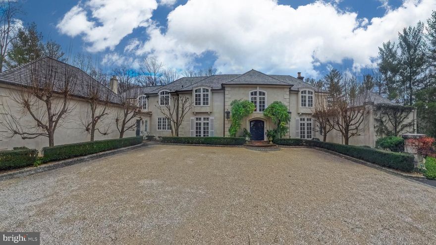 Situated in the heart of Gladwyne, this distinguished residence offers timeless architectural elegance and thoughtfully curated indoor and outdoor living spaces...an additional 1+ acre lot (1115 Waverly Road) is included in the sale.

A grand double-door entry opens to a marble-tiled foyer with soaring ceilings and a sweeping staircase.
The formal living room is highlighted by a dramatic two-story ceiling and expansive floor-to-ceiling windows. A beautifully appointed office features custom wood built-in bookshelves and a fireplace with a striking black marble surround. A second living room, ideally located near the kitchen, is rich in character with cathedral ceilings accented by wood beams, custom wood paneling, detailed crown molding, a fireplace, and a built-in bar alcove, creating an inviting setting for entertaining.
The kitchen is equipped with custom cabinetry, granite countertops, a Dacor gas cooktop, and a         double-door custom Sub-Zero refrigerator. The dining room is a true showpiece, featuring a hand-painted mural ceiling, dual chandeliers, and oversized doors that open to the back patio.
The first-floor primary suite offers a serene retreat with direct backyard access and two ensuite bathrooms, including an updated spa-like bath with a walk-in shower, bench seating, and overhead shower, as well as a second bath with a soaking tub and walk-in shower. Upstairs, six additional bedrooms are complemented by multiple full bathrooms, including several updated baths.
The finished basement adds flexible living space with a recreation area, home gym, and full bath. Outdoor living is elevated by a pavilion-covered patio designed for year-round enjoyment, featuring a substantial brick fireplace with built-in TV, a pool, and professionally landscaped grounds. A three-car garage completes this exceptional Gladwyne offering.