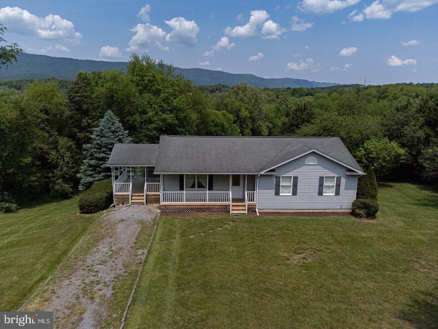 Wonderful Country Home is private location with mountain views situated on 3.68 acres that backs up to a small stream.  This home just need some new floor coverings and a fresh coat of paint and it will be ready to move into.  Features 3 Bedrooms, 2 Baths, Living Room with vaulted ceilings, Kitchen with Breakfast Bar and dining area PLUS front porch, side porch and rear deck.  Walk out  Basement is unfinished but features 1/2 Bath and some walls and ceilings along with laundry area..