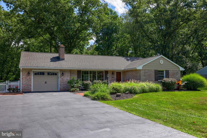 Update: OPEN HOUSE is cancelled. Welcome to 136 Timber Road! Nestled in the highly desired, charming town of Mount Gretna, this fully renovated, move-in ready home is a looking for a new owner. This home features three full bedrooms, two full bathrooms, and beautiful sunroom on the first floor, and a finished basement and half bath downstairs.  Upon entry, you will find stunning oak hardwood floors, original brick fireplace, and custom built ins. The open living room leads into the completely remodeled kitchen and dining area. This kitchen features quartz counter tops, custom kitchen cabinetry and island with a built in microwave, and stainless steel appliances. The kitchen also features a full chalk board wall. The open dining area/kitchen is great for entertaining friends and family. Entering into the sunroom, you will find vaulted ceilings, plenty of natural light with surrounding windows overlooking the peaceful and private backyard views. The full hall bath features a granite counter top vanity, tile flooring, tile shower, and glass shower door. Down the hall you will find the primary bedroom with a en suite bathroom and linen closet. Heading downstairs you will find additional living space with a very spacious finished basement that includes a second brick fireplace, bar and half bath. This space is perfect for entertaining guests or using it as a play room. There is opportunity to add a shower to make this home three full bathrooms. Off of the sliding glass door from the sunroom you will find the brick patio overlooking the large fenced in yard backing up to Gretna's beautiful scenery. This home sits on approximately half an acre. Nature lovers will enjoy watching deer and other wildlife from here! Off the patio you will find brick steps leading to the yard which includes a newly custom built shed, and fire pit.  Other updates include new roof, new windows, recessed lighting, LVP flooring, and new air conditioning system. As a Mount Gretna resident, you will experience all the amazing amenities the community has to offer: The Jigger Shop, Lake & Beach, Roller Rink, Miniature Golf, Playhouse & Theater, Timbers Restaurant, Pizzeria, Hideaway, Historical Society, Governor Dick, yearly Art Show, easy access to PA turnpike, easy access to Rail Trail, and much more! Don't miss your chance to enjoy this move in ready home in the heart of this lovely town.