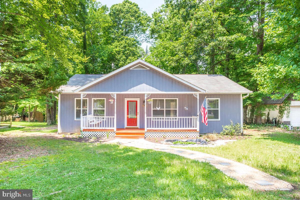 Perfect for those looking for a comfortable home in the peaceful woods. Three bedrooms, two bathrooms, spacious living room and a large eat-in kitchen await. You'll enjoy the front porch with swing, as well as the back porch to enjoy the surrounding natural beauty. Brand new carpet being installed end of July. HVAC, water heater, stove, dishwasher in 2010; washer and refrigerator 5 years old. Kitchen provides ample workspace and a built-in microwave. Crawl space. HOA fee $409 paid annually. Community amenities include: clubhouse, horseshoe pits, beach & boat launch, baseball field, basketball and volleyball courts, playground, campsites, and an airpark. Close to Route 4, shopping and schools. Home is vacant. Seller will pay $5,000 toward Buyer's closing costs.