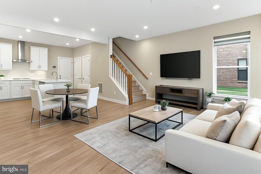 Modern end unit 2-level townhome-style townhome with garage in the sought-after Ashbrook Place community, built in 2022! This beautifully designed home offers an open-concept main level with high ceilings, warm light oak luxury vinyl plank flooring, and tons of natural light from an abundance of windows on 3 sides. Spacious living and dining areas flow into a gourmet kitchen with pristine white 42” cabinetry, beautiful quartz countertops, stainless steel appliances, wall oven, built-in microwave, cooktop with sleek suspended hood vent, and a large peninsula island — perfect for entertaining. A convenient half bath and garage access completes the main level. Upstairs features two generous bedrooms, a versatile loft area with balcony access (easily converted into a third bedroom), and a hall bath with tub/shower combo. The primary suite boasts a wall of windows, plush carpeting, two walk-in closets, and a private spa-like ensuite bath with a dual sink vanity, water closet, and an oversized frameless glass enclosed shower. The attached 1-car garage plus driveway parking adds convenience. The community offers great amenities including bike trails, a dog park, and beautifully maintained common areas. Prime location — just a 5-minute walk to One Loudoun for shopping, dining, and entertainment, and easy access to Dulles Airport, Metro, and DC. If you’re looking for a stylish, contemporary home, featuring designer finishes, comfort, and convenience, look no further this is it!