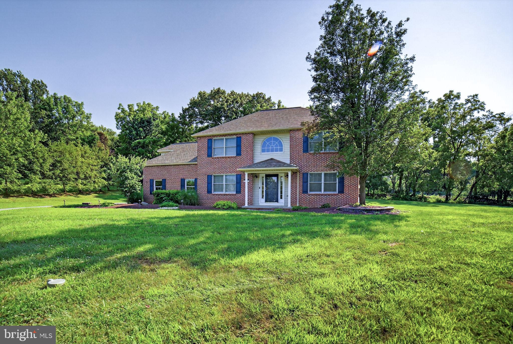 Experience the perfect blend of refined comfort and timeless charm in this beautifully maintained 4-bedroom, 2.5-bath brick Colonial, nestled at the end of a serene cul-de-sac on a sprawling, nearly one-acre lot. Step into the spacious, sunlit eat-in kitchen, complete with sleek granite countertops, premium stainless steel appliances, and elegant tile flooring. A sliding glass door opens to an expansive 21x19 four-season screened-in porch featuring an oversized Jacuzzi tub—perfect for year-round entertaining or peaceful retreat. The inviting living room boasts rich hardwood floors and a cozy brick fireplace with a gas insert, along with direct access to the screened porch. The formal dining room is impressively sized, ideal for hosting gatherings both large and small. Enjoy the convenience of a first-floor laundry room located just off the attached garage. The grand two-story foyer makes a striking first impression with its tiled floors, hardwood staircase, and stylish upper-level window treatments. Upstairs, the tranquil primary suite offers a generous walk-in closet and a beautifully appointed en-suite bath, privately located above the living room for added serenity. Three additional bedrooms share a well-designed full bath with plenty of space for family or guests. The partially finished lower level includes a warm and welcoming family room with a built-in entertainment center. The unfinished portion provides walk-out access to the backyard and abundant storage space. Additional features include an oversized 2-car attached garage with a backyard access door, plus a second detached 12x24 one-car garage—ideal for a workshop, hobby space, or extra storage.
