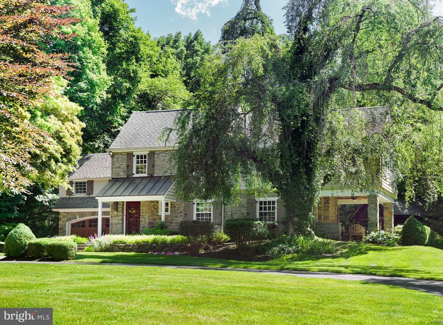 This stunning Main Line stone Colonial on nearly an acre of lush grounds in desirable north Bryn Mawr has been beautifully maintained and expanded with great spaces for entertaining, both inside and out. The home is distinguished by exquisite details, craftsmanship, and charm highlighted by deep window sills and arched doorways and windows. Random width hardwood floors are found throughout the main spaces of the home including the foyer, large formal living room with fireplace, and the lovely dining room with bay window, chair rail molding and custom corner cabinets. The kitchen, which features cherry cabinets, granite countertops, 5 burner gas cooktop, and large center island with seating, opens to the spacious breakfast room and family room. The sunny, open breakfast room and family room has vaulted ceilings with exposed beams, a stone fireplace, and access through French doors to the large patio with fountain feature - truly the heart of the home! 2 powder rooms, laundry room, and access to the attached 2 car-garage complete the first floor. On the second floor, your gorgeous master bedroom suite awaits with stone fireplace and private sitting room. The large bath has a tiled shower stall and double sinks. 3 additional bright and spacious bedrooms and bath with tub occupy the 2nd floor. You ll love spending time with family and friends in the many outdoor entertaining spaces. The paver patio has room for large gatherings, while the screened in custom built cedar gazebo with exposed beams will quickly become one of your favorite spots for outdoor dining. Perfectly nestled among the trees creating the ultimate outdoor dining experience. And finally, the side flagstone covered porch with ceiling fan, which overlooks the lush, level grounds, is a great spot to unwind in the afternoons and watch the little ones play. To top it off, you can t beat this location - walkable to historic Harriton House, the train station, award winning schools and just minutes away from Bryn Mawr s many shops, restaurants and more!
