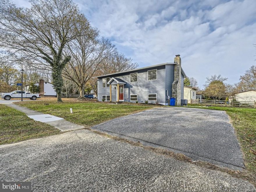 Beautifully renovated 4BB/2BA split foyer Ranch located on a spacious lot in the desirable neighborhood of Oakland Mills.  Pull into the double wide driveway, make your way to the covered front entry and open the door into your forever home.  Step inside to a bright and airy open concept main floor plan featuring gorgeous flooring, and recessed lighting throughout.  The spacious living room beams with tons of natural light and offers an open view into the spacious dining room and stunning kitchen.  The kitchen features plenty of cabinets, stainless steel appliances, quartz countertops with a beautiful complimenting backsplash, and a deep stainless sink set into a large island with breakfast seating for three or more.  Down the hall is a large primary bedroom, two spacious secondary bedrooms, and a full bath with a double sink vanity, a shiplap wall, and stacked tile from ceiling to tub.  The lower level offers additional living space including the fourth bedroom, a full bath with a beautifully tiled walk-in shower, a large family room with a wood burning fireplace surrounded by a brick facade and a wood mantel, laundry, storage, and sliding door to the oversized yard.  The yard is filled with tons of green space and possibilities. This home is move-in ready with so much to offer new homeowners.  Imagine all this and in close proximity to shopping, restaurants, and commuter routes.