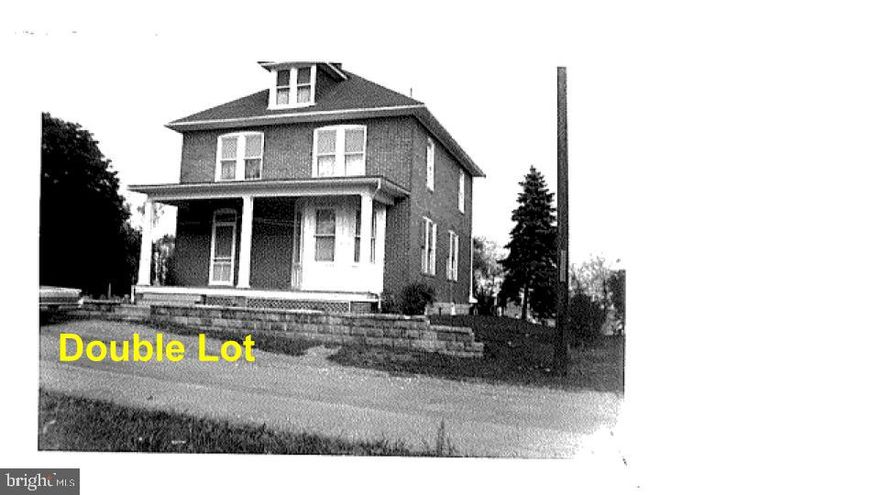 Welcome Home to this 4 bedroom, 1.5 bath colonial, offering classic charm and modern convenience. All-brick that has been finished over with vinyl siding. Generous room for everyone with 2,535 sq.ft. of living space. Eat-in kitchen for casual dining. Separate dining room ideal for family meals. Four comfortable bedrooms on upper level with a full bath. Extra storage space in the attic. Enjoy your morning coffee or unwind in the evening on the lovely front porch. Situated on a double lot providing ample yard space for play or entertainment. Offering two sheds, and a detached oversized 2-car garage. Selling as-is. Low taxes - no city taxes and no HOA. Minutes from I-81 and I-70. Don't miss your opportunity to make this yours!