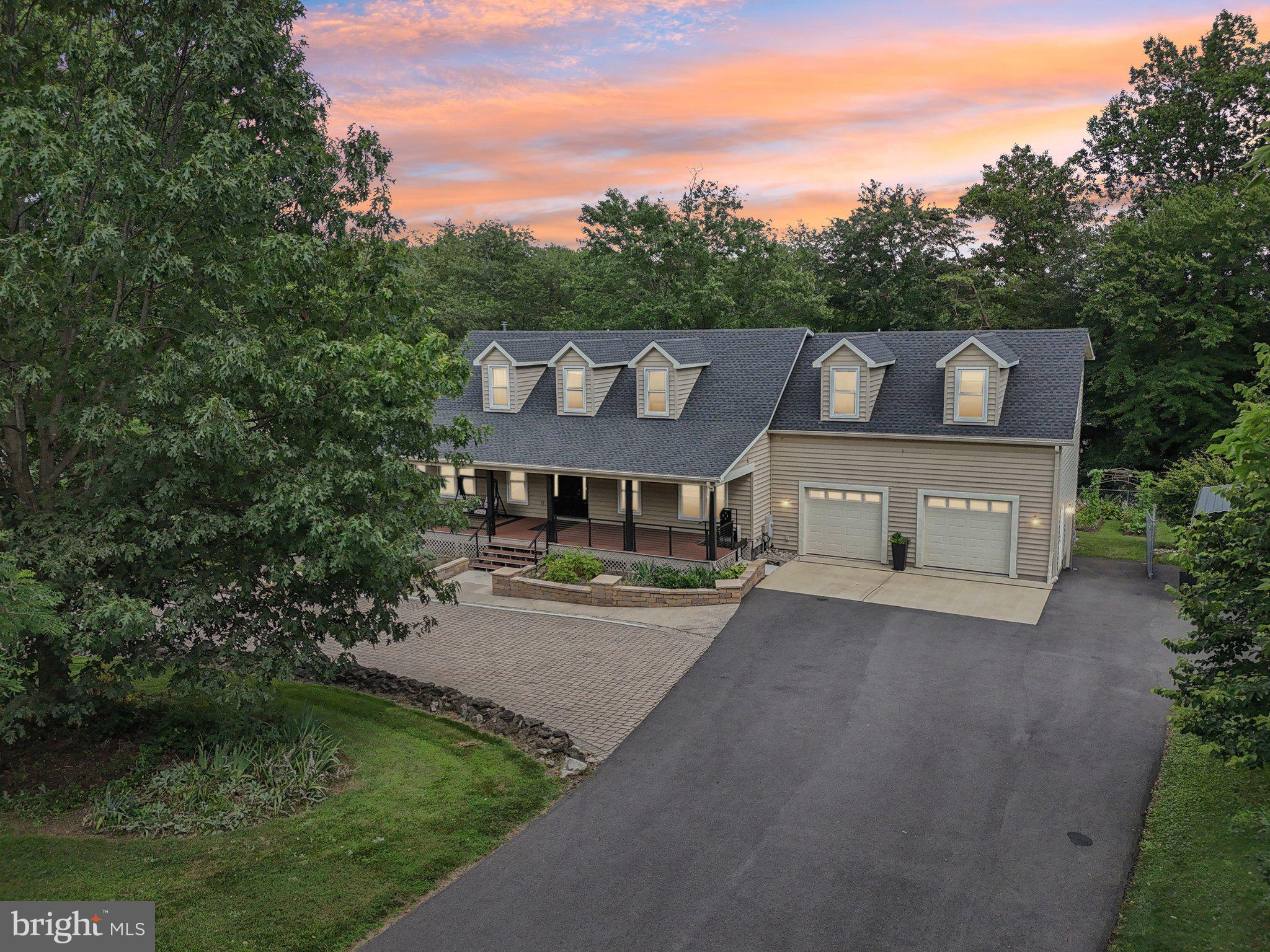 Set behind a landscaped privacy berm just off Rt 27, this beautifully maintained Cape Cod offers over 4,500 finished sq ft of living space. As soon as you enter, you’ll experience an artful richness of textures and colors throughout. With 6 bedrooms and 4 full baths, the layout is perfect for multi-generational living, entertaining, or working from home.
The main level features wide-plank mahogany hardwood floors and a gourmet kitchen with granite countertops, an oversized island with cooktop and vent hood, a wall oven, a wine fridge, and a French-door refrigerator. From the kitchen, step out to a massive 800 sq ft Trex deck, ideal for outdoor entertaining and relaxing. A guest bedroom and full bath on the main level offer excellent flexibility for visitors or single-level living.
The walkout lower level includes a home theater (equipment conveys), a large rec room with wood stove, a sixth bedroom or office, full bath, full-sized side by side refrigerator and sliding glass doors to a private covered patio with hot tub. With its separate entrance and full bath, the space could easily be converted into an in-law suite.
Upstairs, the primary suite features vaulted ceilings, a walk-in closet with organizers, and a luxury bath with Jacuzzi tub and multi-head tiled shower. Three additional bedrooms, a full hall bath with skylights, and a convenient upstairs laundry complete the upper level.
Outside, enjoy six distinct garden areas including a koi pond, greenhouse, rainwater collection system (200+ gal), and a fully fenced vegetable/herb garden with blueberries, medicinal herbs, loofah, hydrangeas, wisteria, and other year-round blooms. A 500+ sq ft Trex front porch spans the home’s front elevation and includes an accessibility lift from the driveway.
Additional highlights include: A temperature-controlled 2-car garage with separate furnace and AC,
RV carport and brick paver driveway, Shed and large under-porch storage (fits 2 vehicles), Propane heat (1,000-gallon owned tank),
4+ cords of firewood, recessed lighting, built-in storage, and closet organizers
Greenhouse, dining room set, and all appliances convey. This property is a rare blend of comfort, natural beauty, and thoughtful upgrades—just minutes from amenities, yet worlds away in feel.
Welcome to Damascus — a small town with a big-town heart!