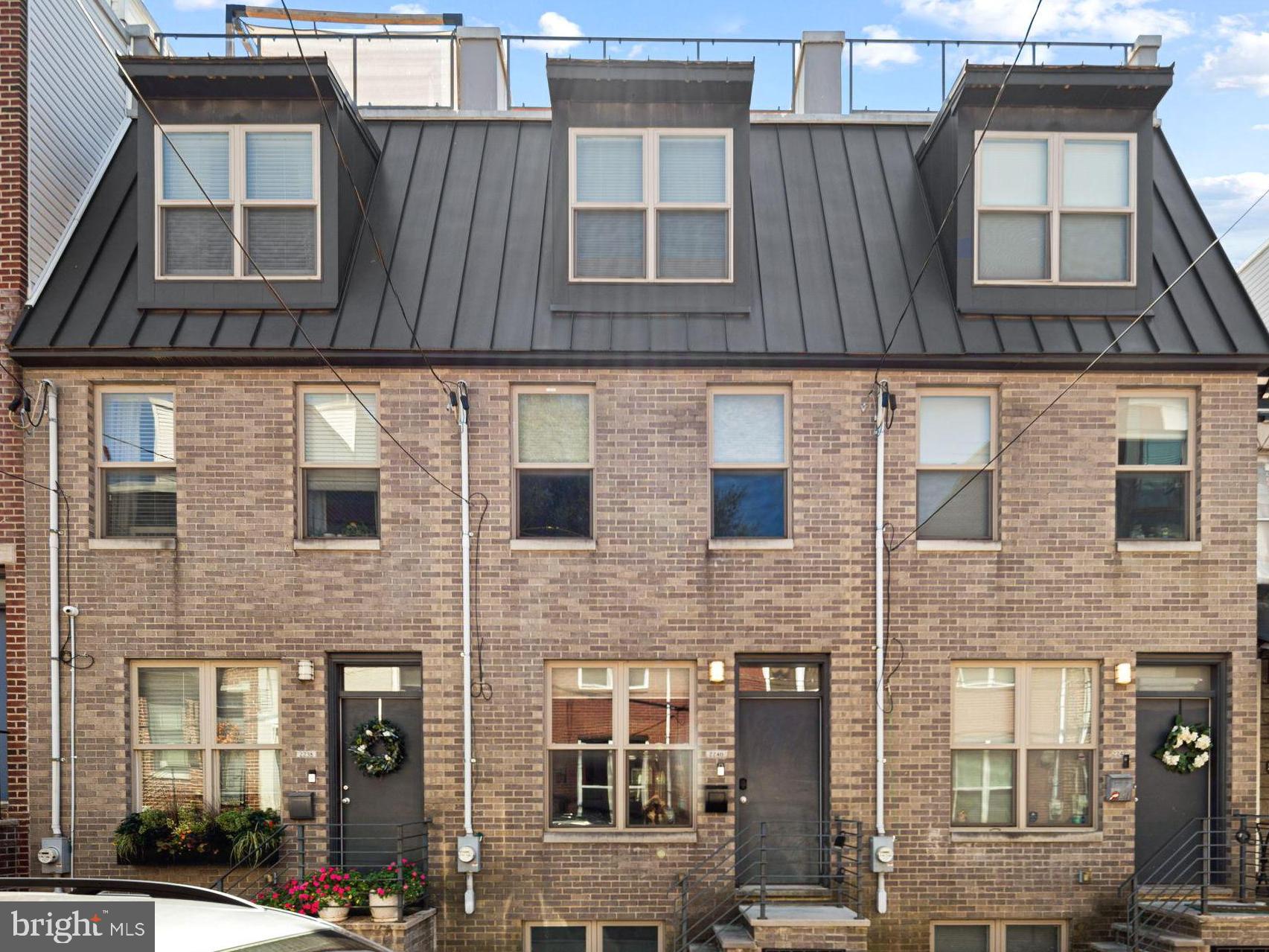 This modern beauty offers 3 bedrooms, 3 full bathrooms and 2 outdoor spaces. This home was built in 2018 so offers the luxuries of new construction plus also has a few years left on the tax abatement. As you approach the home, notice the mansard roof detail on the 3rd floor, an elegant element of design. As you enter the home, take note of the extra tall ceilings which make the home feel even larger than it is. Hardwood floors can be found thorough the home, including the main floor. The living room flows right into the dining room and then onto the kitchen. The kitchen, wow! Two tone cabinetry paired with a granite countertop that compliments the cabinets makes for a really beautiful space. There is plenty of kitchen countertops here, including the peninsula which can seat 2. A double wide sliding glass door with a transom window leads you to the nicely sized back patio. On the second floor of the home you will find 2 bedrooms, a shared hall bathroom and the laundry room. Both bedrooms are a great size and have ample sized closets with lights. The hall bath has a tiled shower and floating vanity and mirrored medicine cabinet for plenty of storage. On the third floor is the primary suite. The bedroom has ample room for a king sized bed plus more furniture. A cute built in bench can be found at the front window. Pass the walk in closet(!) as you head towards the en-suite bathroom. The bathroom features a dual vanity with leathered granite countertops on top of a sleek floating vanity. The shower has dual shower heads with a glass surround and marble tile. The basement is fully finished and offers two separate spaces. One space at the front and another in the rear, which could be used as a bedroom. There is also a full bathroom in the basement. On the top of the house is your private roof deck, perfect for looking at the city skyline! A wet bar with beverage center is located on the top floor, great for morning beverages as you get ready or evening drinks on the roof deck. The owner has installed Hunter Douglass shades throughout the home and there is Ring doorbell hardwired for security. This home is just 1 block from Wharton Square park which offers a kids playground plus tennis courts and plenty of space to hang or walk around. Easy access to Center City and University City via biking, walking or taking the bus.