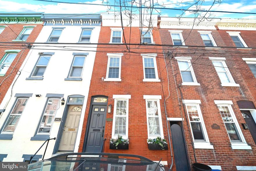 Nestled on one of Philadelphia's most desirable tree-lined streets, 2444 Meredith Street exudes timeless elegance and historic charm. This exquisite home seamlessly blends old-world allure with modern sophistication. Intricate decorative moldings and high ceilings pay homage to its storied past, lovingly maintained by its current owner. Upon entering, you are greeted by a harmonious blend of classic and contemporary styles. A small concrete patio off the kitchen provides a perfect space for grilling, while the private rooftop deck offers a tranquil retreat with stunning panoramic views. The home boasts numerous upgrades, including new windows in 2012, refinished hardwood floors throughout, custom closet systems, and built-ins added in 2018, and new interior doors in 2019. A full electrical replacement with added recessed lighting was completed in 2020, new hot water heater in 2020.  Waterproofed basement which included french drain and sump pump in 2020. The primary bathroom was elegantly redesigned and upgraded in 2022, and the HVAC system was replaced in 2023. This residence offers abundant storage, with charming built-ins enhancing its character. The unfinished basement provides additional storage.  Meticulous attention to detail throughout reflects a commitment to quality and style, making this home a testament to timeless elegance and thoughtful design, offering an exceptional living experience.