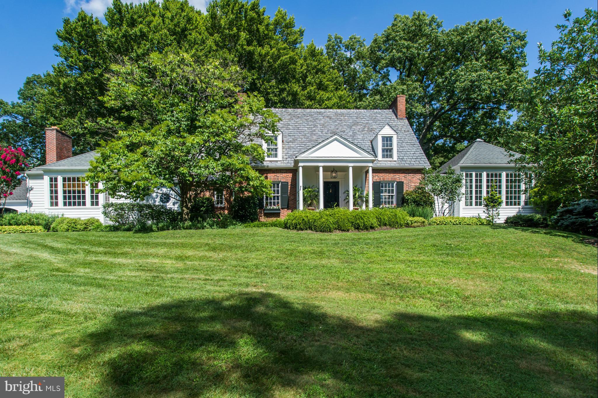 Beautifully proportioned brick 4BR, 4/1BA Georgian home w/extensive expansions. Classic entry portico, formal LR w/FP & banquet-size DR. Vaulted SunRm w/wet bar, custom gourmet Kit w/marble, vaulted FamRm w/FP & built-ins, Study. Sumptuous 1st floor MBR suite w/FP & SpaBa, finished LL w/2 large Offices. 3-car Garage, glorious gardens, patios & Koi pond.