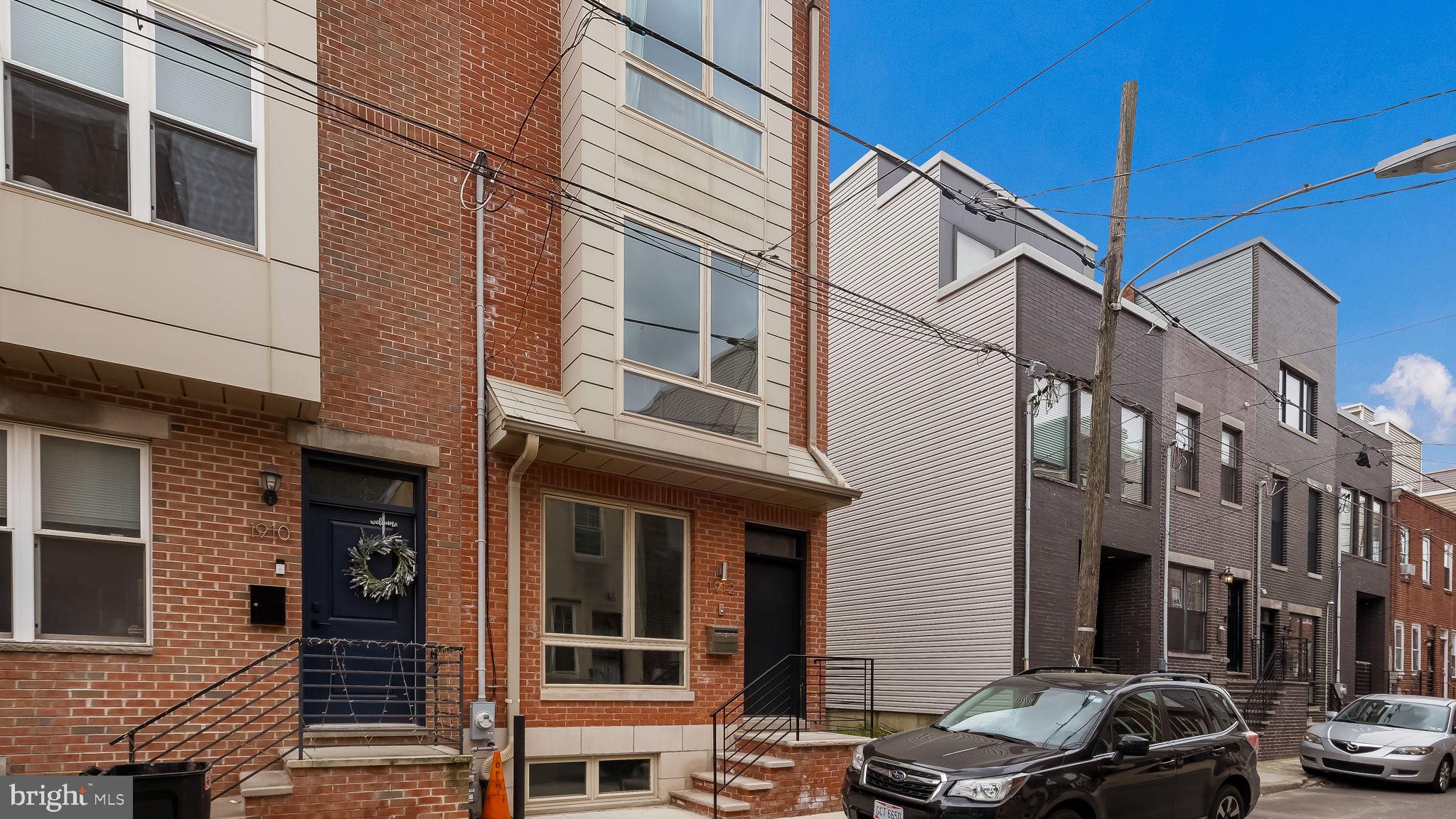 Welcome to this custom 3 BR, 2.5 Bath, 3-story home in South Philadelphia in Point Breeze! Stunning maple hardwood floors on all upper levels & recessed lighting throughout. This gorgeous home offers a first floor with a large Living & Dining room that overlooks the well-appointed Kitchen offering custom 42" cabinetry with soft-close doors & drawers, quartz countertops, custom tiled backsplash, stainless steel appliances & a large center island/breakfast bar with deep under-mount stainless steel sink & custom pendant lighting. Sliding glass door in the Kitchen leads to a private fenced patio. Staircase with custom railing leads to 2nd level with 2 large bedrooms & full hall bath with tub/shower combination & custom ceramic tile floor & walls. The 3rd level features a Primary Bedroom with a spacious walk-in closet & luxury bath with a floating double vanity, seamless glass shower with custom tiled walls & floor & built-in shelving for additional storage. Just outside the Primary bathroom is a built-in recessed cabinet & beverage fridge. From the 3rd level, you can also access the roof deck with electric & water lines & gorgeous views of Center City. Full, finished Basement with Laundry area, Utility area & powder room with ceramic tile floor. High-efficiency HVAC, extra-large, high-efficiency casement windows.