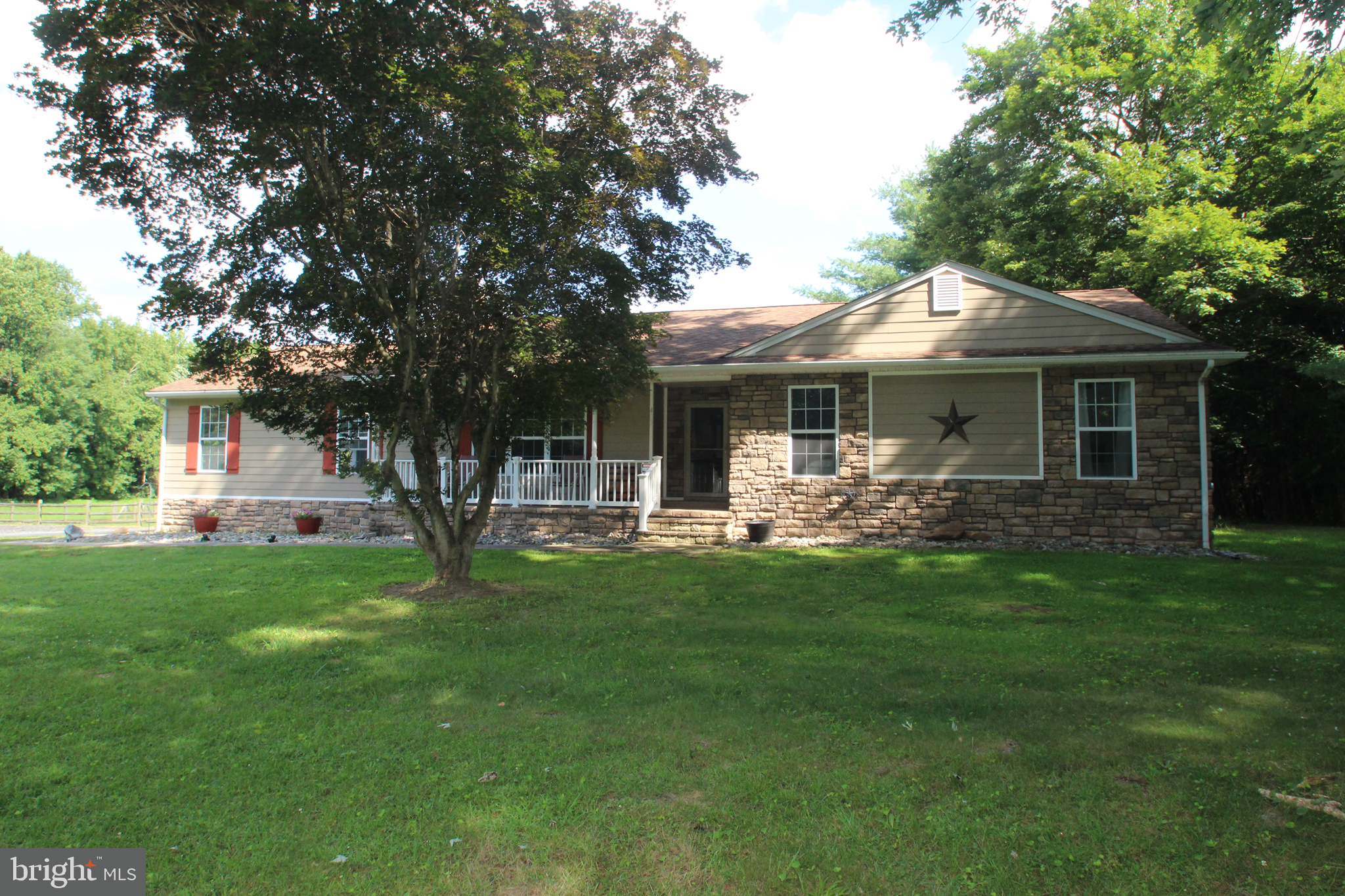 Welcome to this cozy ranch home located in the beautiful area near Chesapeake City, convenient to the Ben Cardin C&D Canal Trail, Schaefers Canal House, Chesapeake Inn and other fine dining restaurants. This spacious property boasts 4 bedrooms and 3 full bathrooms, kitchen with 42" cabinets, tile backsplash, pantry and Granite counters. As you enter the home, you are greeted with a wealth of interior features including wood floors, bar area with pellet stove, great room with Harmon pellet stove and a cozy woodburning fireplace in the dining room. The finished lower level offers extra living space with a large bedroom with woodburning fireplace and full bath, small music room, rec room and bilco door. Step outside to the expansive 9.5 acres of, mostly cleared land, complete with an above-ground pool, for those hot summer days, and 1000 sq ft paver patio with built-in fire pit and hot tub - ideal for outdoor gatherings and summer BBQs. For the car enthusiasts, the detached garage comes equipped with a car lift, making it easy to work on and store your vehicles. Additional features such as Hardy Plank siding, ceiling fans, and a hot tub add to the appeal of this amazing property. Don't miss your chance to own this exceptional home with a perfect blend of indoor and outdoor living spaces. Schedule your tour today before it's gone!