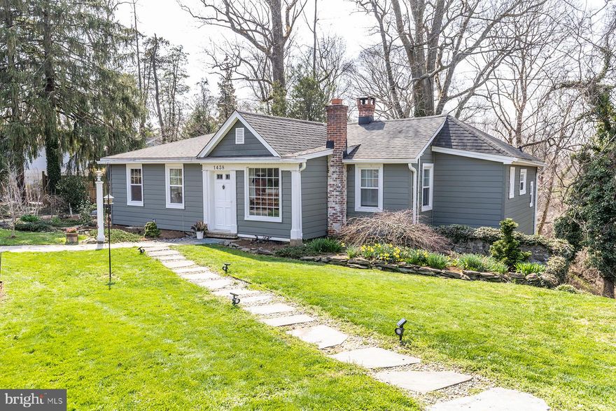 Step into the waterfront lifestyle in water privileged Pines on the Severn!  Nestled on a large corner lot in the lower Pines, this appealing cottage enjoys beautiful, professionally landscaped grounds and hardscaping.  Major exterior renovations in 2022 include crisp Ascend siding, all new windows, French doors and gutters. The original wood floors throughout the majority of the home are priceless.  The kitchen was tastefully renovated in 2022 with quartz countertops, white cabinetry, appliances and grey slate floors.  Relax in the living room in front of a gracious stacked stone fireplace, which opens to the dining area featuring a wall of windows providing abundant natural light. (winter water glimpses) Two bedrooms on the main floor with ensuite baths and a walk in closet.  The lower level is a fully equipped suite with living room, bedroom, bath, kitchen, walk-in closet and sunroom.  There are French doors that open to a stone patio that is one of several attractive outdoor entertaining spaces. There is also an office and a tiled laundry room in the lower level.  The backyard overlooks the ravine and green space and has an additional brick structure for outdoor relaxation and cooking. The front of the home faces the Pines park and is enclosed by a brick wall affording privacy.  Enjoy community living at its finest with all the wonderful Pines amenities including a sandy beach with covered picnic area,  boat ramp,  community assigned boat slips and moorings,  canoe and kayak storage,  playground, ball fields, BB, tennis and pickleball courts, Community pool (separate membership) and proximity to the B&A Trail for walking, jogging, biking enthusiasts.  Minutes to downtown Annapolis and easy access to Route 50 and major routes.  Broadneck Schools.