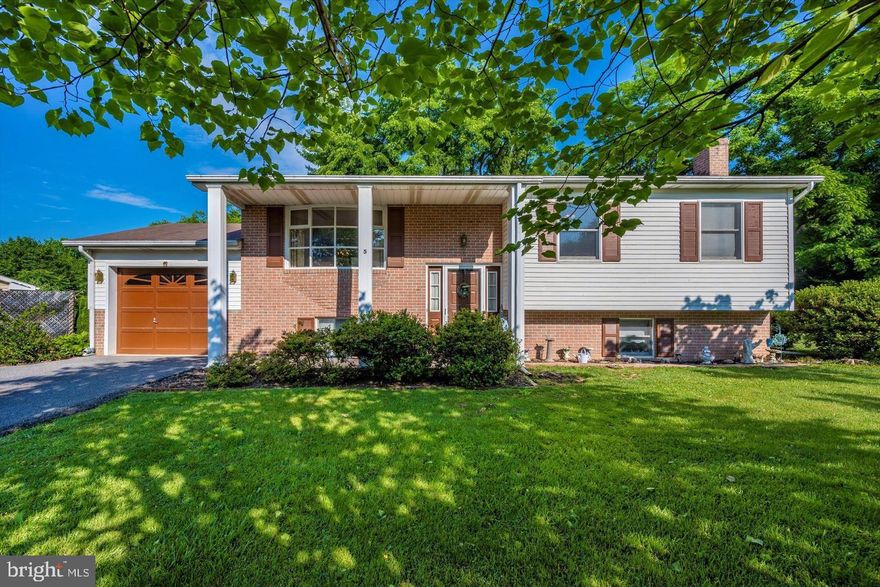 Bright and Sunny Split Foyer offers a large living room with picture window, eat-in kitchen and dining area with walk out to deck, Master bedroom with private bath and walk in closet, second bedroom and hall guest bath on main level. Lower level offers a spacious family room with flu for wood stove with brick surround. Third bedroom, laundry, half bath and plenty of storage. Located on a cul-de-sac with a one car garage, spacious driveway with parking for 3 more cars. Large front & back yard, shed, deck and patio for entertaining!