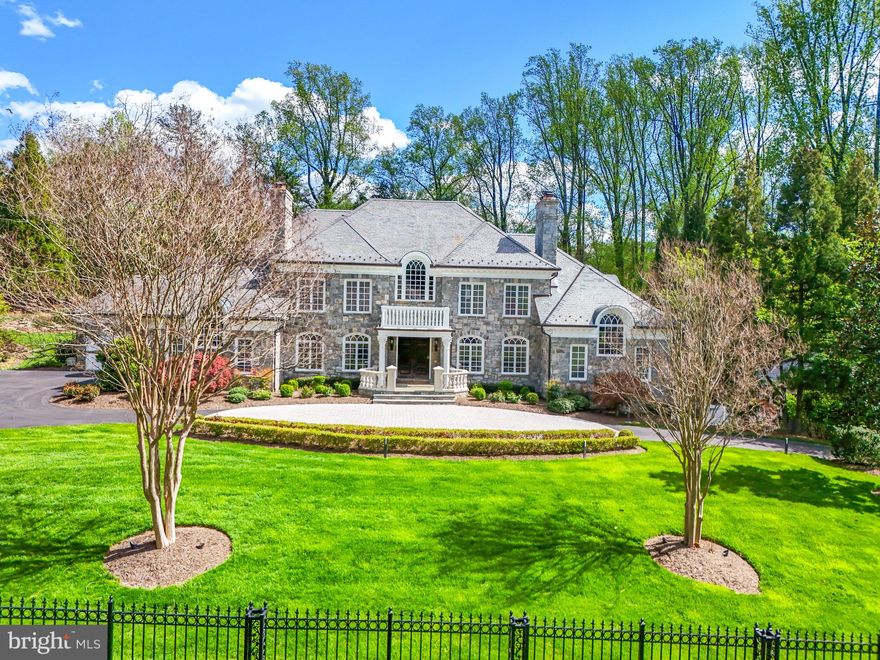 Welcome to 1221 Mottrom Drive. A Private Oasis in a Coveted Location. This spectacular estate, well over 12,000 square feet, is nestled in one of the area's most sought-after neighborhoods and crafted by renowned builder George Sagatov. Privately gated and set behind a circular driveway, the home makes an unforgettable first impression with its striking curb appeal, lush professional landscaping, and a sparkling resort-style pool. Step inside the grand two-story foyer, where a dramatic curved staircase sets the tone for the refined interiors that follow. The formal living room and banquet-sized dining room each feature their own fireplaces, elegant mantels, and arched doorways that add architectural charm. The heart of the home is the breathtaking great room with a floor-to-ceiling stone fireplace, coffered ceiling, and a wall of windows that flood the space with natural light and offer seamless access to the custom deck, perfect for indoor-outdoor living. The chef’s kitchen features custom cabinetry, a large center island, two dishwashers, a built-in coffee maker, warming drawer, and a work desk area. Also on the main level is a richly paneled private office with built-ins and a fireplace, as well as a spacious main-level primary suite with a walk-in closet and luxurious bath complete with separate vanities. Two powder rooms and a well-appointed laundry room complete the main floor.
Upstairs, the impressive owner’s suite is a true retreat with its own sitting room, fireplace, two generous walk-in closets, and a spa-like bathroom with separate vanities, soaking tub, and oversized shower. Three additional ensuite bedrooms provide comfort and privacy for family and guests. The walk-out lower level is an entertainer’s dream, featuring a fully equipped wet bar, wine cellar, state-of-the-art media room with tiered seating, a fitness room with sauna, a recreation room with stone fireplace, and an additional bedroom and full bath. Step outside to a true backyard paradise. The sparkling pool is complemented by a fully outfitted pool house with a full kitchen and bath, perfect for summer entertaining. Every detail of this home has been thoughtfully curated for luxurious living, all just minutes from the shops, restaurants, and commuter routes of Tysons Corner.