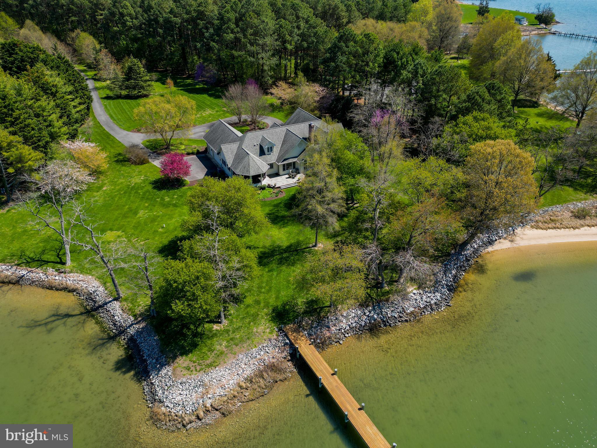 Exceptionally maintained 4 acre home situated on Plaindealing Creek with coveted western exposure and deep water dockage, 5+ MLW at private 6' wide pier with electric and water. Approximately 350 ft of rip-rapped shoreline and the well-manicured grounds are more like a private park with carefully chosen annuals and trees that provide blooms throughout the year. This custom-built, single-level brick home designed by Linda Spring, features formal living and dining areas, bonus room, as well as waterside family room, office/den, primary suite with massive walk-in closet and spa-like bath, and an ample kitchen with island and table space. Screened porch is perfect for enjoying the colorful sunsets or hosting a traditional Eastern Shore crab feast. Centrally located between St. Michaels and Easton, it's the perfect place to get away from it all, yet enjoy being just minutes to dining, shopping, entertainment, golf, and more!