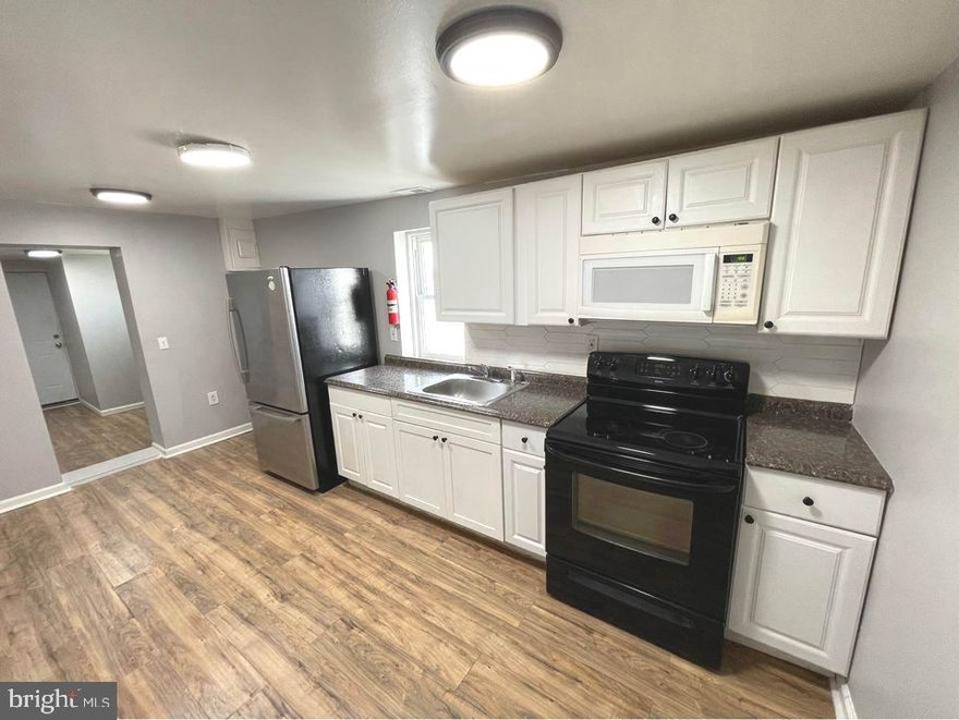 ALL UTILITIES AND CABLE INCLUDED - Updated 2 bedroom / 1 bath apartment available for immediate occupancy. Unit has a full spacious kitchen, new engineered wood floors throughout, and central air conditioning. Includes all utilities and cable. Coin laundry on site. Convenient location in Rosedale - close to major roadways. On-site Property Manager and Security cameras on site. Off street parking included. This property is a 21 unit property with 16 residential apartments, 3 commercial garage bays, and 2 detached houses.  This unit is one of the 16 residential apartments.  Minimum term of 6 months - sorry, no pets.