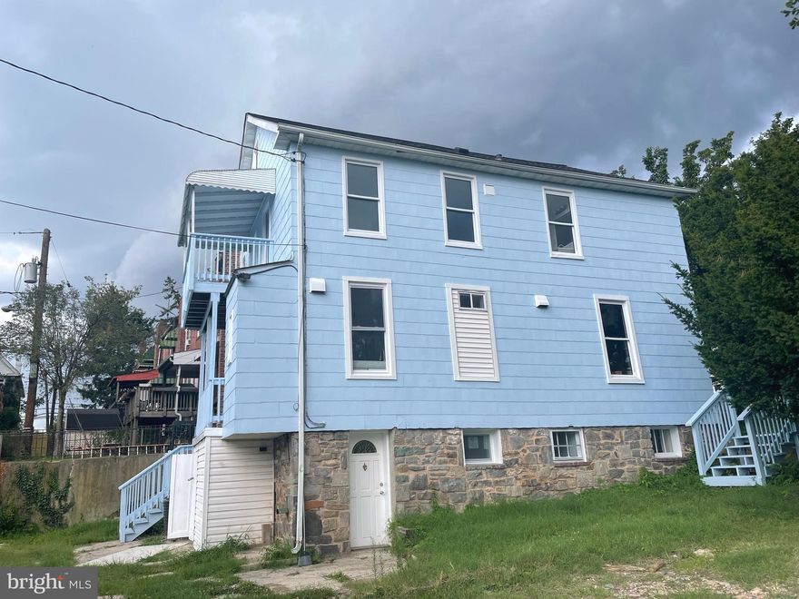 HOUSE IS CURRENTLY TENANT OCCUPIED AND SELLER WILL HOST OPEN HOUSE. Newly renovated.  New central HVAC. New Roof.  On the corner of Wilkens and Wilmington Ave. Close to St. Agnes Hospital and Babe Ruth fields. House has dining, living, kitchen, laundry, 1 bedroom and 1 full bath on main floor, 4 bedrooms and 1 full bath on upper level; walk-out basement was built out as 1bedoom apartment. 2 balconies. High ceiling attic space. Also, it has 8 1-car garages plus 1 big garage space for more than 2 cars. Garage spaces can generates $1000 per month rent.