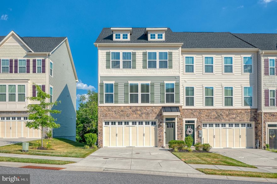 Gorgeous end of group townhome with 2 car garage!  Large Open Floorplan with family room, gourmet kitchen with 42" cabinets, double oven, and granite, dining area, built in desk/office space, and powder room on main level.  3 bedrooms on upper level includes large owners' suite with beautiful bath + hall bath - double sinks.  Laundry on upper level.  Lower level family room or additional bedroom with full bath.  Wood floors throughout and 9' ceilings.  Built in shelving in all closets and pantry. Deck, backs to trees/common area. Custom lighting and ceiling fans throughout.  Shows like a model.  Close to shopping and major roads.