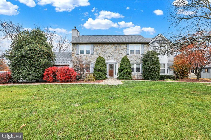 Timeless 2-story stone colonial, nestled on a corner lot.  As you step through the front door, you're greeted by a welcoming foyer with hardwood floors that flow into the formal living room, dining room, guest half-bath and kitchen. Quaint features like pockets doors, bow windows, built-in wall cabinets and rich wood grains give a warm feeling of home. 

The heart of the home is the kitchen, featuring cherry cabinets, Corian countertops, backsplash, and a convenient pantry with organizers. The island, L Shape countertop, newer gas stove, built-in microwave, and refrigerator make meal prep a breeze. The adjacent dining room, with its tile floors and pocket doors to the family room, is perfect for hosting dinner parties.

The addition to the home offers a versatile family room, a sun-drenched sunroom with skylights and French doors to the rear porch, and a luxurious master suite. The master suite boasts a spacious sitting room, a laundry area, a full bath with 2 sinks, and a dressing area with ample closet space. Two additional bedrooms, one with a walk-in closet & ceiling fans share a full hall bath.

The partially finished basement, complete with a built-in gas heater, 30 year roof with 50 year Fish Scale Shingles, and ceiling tiles. The home also features a newer gas heating system, 2 central air units, water softener, U/V Light and 2 car garage with new (Fortress Floors) Polyurea Floor coating.

Outdoor living is a dream with a covered back porch spanning the length of the home, equipped with 5 skylights, 3 ceiling fans, speakers, and recessed lighting. The upper (36 x12) and lower (26x16) Trex decks provide ample space for relaxation and entertaining. The in-ground pool, replastered in 2023, offers a refreshing escape, complete with built-in remote controlled lighting, a water fountain feature, and a flagstone patio. Two gazebos, a hot tub, and a pool shed round out the outdoor oasis.

The remaining time of the  warranties are transferrable for the garage floor,  heater and air conditioning unit. Also, the American Home Shield Home Warranty is transferrable as long as the monthly payment of $181.84 is continued.