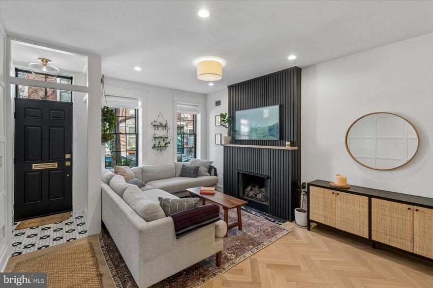 This fully custom, impeccably renovated residence blends timeless character with modern sophistication, where every detail has been thoughtfully curated to create a truly refined living experience.

Upon entering, you are welcomed by a bright and expansive open floor plan with beautifully defined spaces for both living and dining, seamlessly flowing into a chef’s kitchen designed for both elegance and functionality. The main level showcases stunning herringbone hardwood floors, custom wall paneling, designer lighting, and oversized windows that flood the home with natural light. The kitchen features high-end appliances, abundant custom cabinetry, and refined finishes, making it the perfect centerpiece for everyday living and entertaining.

Just beyond the kitchen, step into your private backyard retreat, surrounded by tall privacy fencing and walls—an ideal space for relaxing or hosting gatherings.

The second floor offers two spacious bedrooms, each featuring custom-built closets and large windows, along with a beautifully appointed hallway bathroom and a convenient laundry room.

The entire third floor is dedicated to the luxurious primary suite, offering a generous bedroom, extensive custom closet space, and a spa-inspired bathroom highlighted by a freestanding soaking tub and elegant finishes.

The rooftop deck provides stunning Philadelphia skyline views, creating the perfect setting to unwind while enjoying sunsets and elevated outdoor living.

The fully finished lower level features tall ceilings and an expansive flexible living area ideal for a media room, gym, or additional lounge space, along with a full bathroom and fourth bedroom featuring a wall-to-wall sliding door that allows abundant natural light.

This home has been completely renovated from top to bottom, including all new mechanical systems, plumbing, and electrical, offering modern efficiency and long-term peace of mind. The carefully executed renovation introduces distinctive custom interior design elements throughout, giving the home its own unique charm, warmth, and character.

Adding further value, the property benefits from approximately a 7-year tax abatement, providing significant savings for years to come.

A rare opportunity to own a truly exceptional, turnkey residence.

Nestled on a quiet, charming tree-lined street, this home enjoys an unbeatable location in the heart of Graduate Hospital within the highly sought-after Greenfield Catchment. Just a short walk to Fitler Square, Rittenhouse Square, Schuylkill River Park & Trail, and within close proximity to UPenn, Penn Medicine, CHOP, and HUP, the home offers exceptional access to some of the city’s most desirable destinations. Enjoy being steps from top restaurants, cafés, and boutique shops, while also benefiting from easy access to major highways including I-76, I-95, and Route 476, making commuting effortless