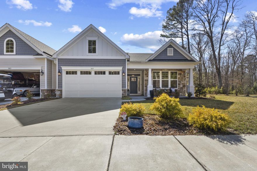 Welcome to this beautifully upgraded home at the Enclave in Prospect Bay, the Eastern Shore’s premier golf course community, offering main-level living, thoughtful design, and premium finishes throughout. Perfectly situated on a premium lot, this home blends comfort, style, and functionality both inside and out.
Located on a private lot next to the golf cart path with access to Prospect Bay’s 18-hole golf course, you are greeted by a welcoming covered front porch as you arrive. The main level features a spacious primary suite along with two additional bedrooms and two full baths, providing convenient single-level living. The primary suite showcases elegant tray ceilings and a luxurious ensuite bath with a frameless glass shower. Upstairs, a versatile loft with LVP flooring and surround sound offers flexible living space and includes a third full bath, giving it the potential to serve as an office, guest suite, or recreation room.
The upgraded kitchen is a standout, featuring enhanced cabinetry, KitchenAid appliances, under-cabinet lighting, and a stand-alone ice machine, making it as functional as it is beautiful. The kitchen opens to the living room and a dining area overlooking the paver patio and the 11th hole of Prospect Bay’s golf course. Also located on this level is a spacious office with barn doors. With direct access to the garage, the conveniently located laundry room continues the upscale finishes with upgraded cabinetry and granite countertops.
Designed with both style and entertaining in mind, the home features luxury vinyl plank flooring throughout the main living areas and primary bedroom, tray ceilings in the primary bedroom, dining room, kitchen, and living room, and crown molding in all main-level bedrooms and living spaces. Stylish board and batten molding and a custom wall mural in the main hallway and main-level office add distinctive character. Smart and modern touches include motorized blinds and a surround sound system in both the living room and loft.
The garage is fully finished and thoughtfully upgraded, featuring complete interior painting, custom epoxy flooring, and built-in shelving for additional storage. Above the garage, extended pull-down stairs provide convenient access to additional storage space. Outdoor living is just as impressive, with a sealed and coated front porch and a paver patio with a gas-lit fire pit, perfect for relaxing evenings or entertaining guests. The community maintains the gardens and lawn, offering a true turn-key experience.
Located within the exclusive Enclave at Prospect Bay, residents enjoy access to a wealth of amenities including an 18-hole golf course with pro shop, driving range, tennis and pickleball courts, a members-only clubhouse with restaurant and bar, community pool, playground, private boat launch, and more. Whether you're seeking a full-time residence or a weekend escape, this golf course-view property offers an unmatched lifestyle in one of Maryland’s most prestigious communities.