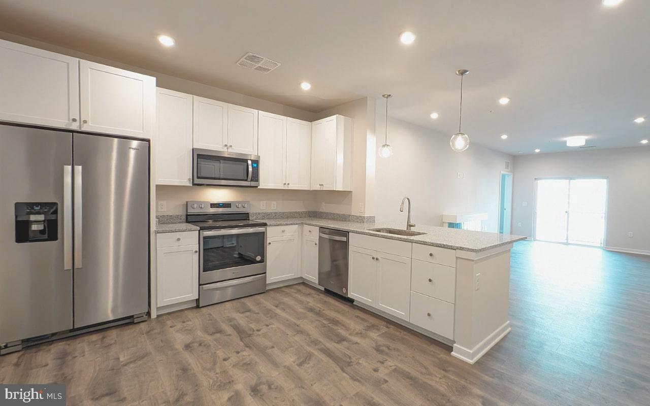 **FINAL HOMES** NEW CONSTRUCTION / 55+ COMMUNITY Special all-in price! Austin home for immediate move-in. This 4th-floor home has two bedrooms & two bath with north views. Hosting friends is ideal in your open-concept living & dining room. Adjacent to the kitchen, you'll find a flex space that you can transform into your own private retreat for work or your favorite hobbies. Relax and unwind in your spacious primary bathroom, equipped with an oversized shower & dual closets for your comfort. Blinds are included on all windows. Revel in a resort-like getaway every day in the Austin. Dedicated covered parking space and storage unit included. **BY APPOINTMENT ONLY****
**For a limited time receive $15,000 in Closing Costs through 8/31/25 (Closing assistance tied to Choice Lender; must settle on or before 9/30/2025).* Additional Restrictions may apply.
Gatherings® at Potomac Station is just minutes from Historic Downtown Leesburg - enjoy brand-new condos close to shopping & dining! Look for parking along California Avenue near the paved steps/ramp between the main buildings. Follow the signs and take the steps or ramp to our building entrance. Please use keypad to call our 2nd-floor MODEL SALES OFFICE.