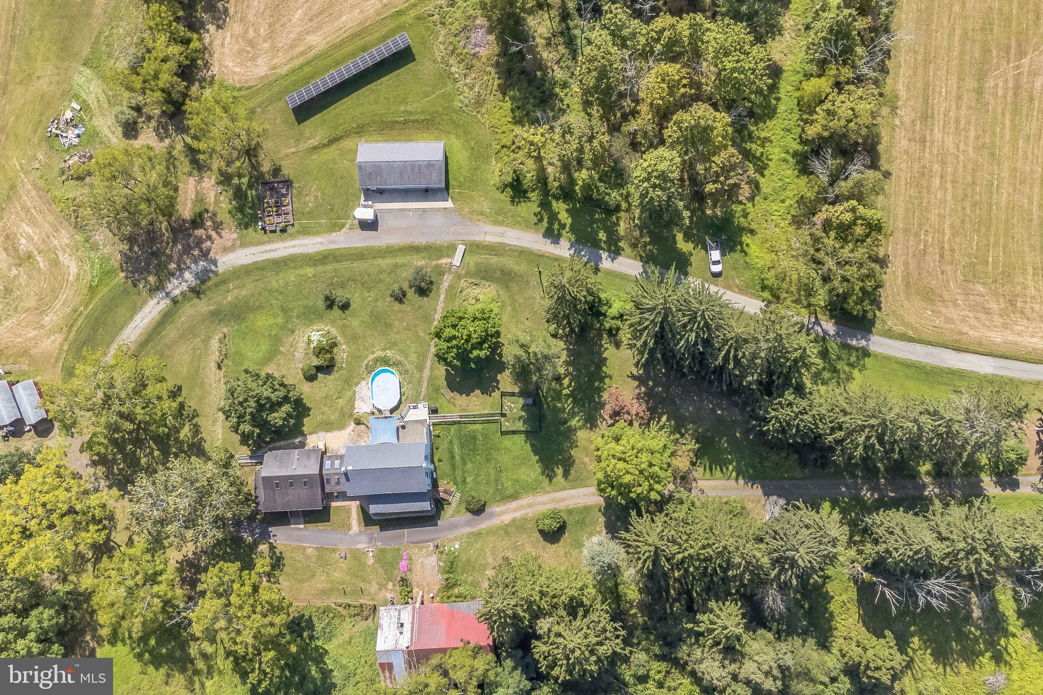 Experience peaceful living on this unique property featuring a U shaped driveway. Directly across from a 19th century bank barn and a 5 acre fenced pasture, this home offers both wooded and cleared areas, with the Perkiomen Creek running along two sides, perfect for fishing.
The entire property boasts a 60-panel solar array, eliminating the need for oil heat, while electric heating and a Jotul Oslo wood-burning stove keep the main house comfortable year round.
Enjoy the sunroom with exposed stone, skylights and a serene spot for morning coffee.
This property includes three red 12’ x 24’ sheds, a large insulated 3-bay garage with workshop, a fenced raised bed garden, and even a practice golf hole with sand trap. The in-law suite, built in 1999, features a handicap ramp, wrap-around porch, great room with vaulted ceiling, sky lights and oak beams, 1 bedroom, 1 full bath and it’s own laundry room.
