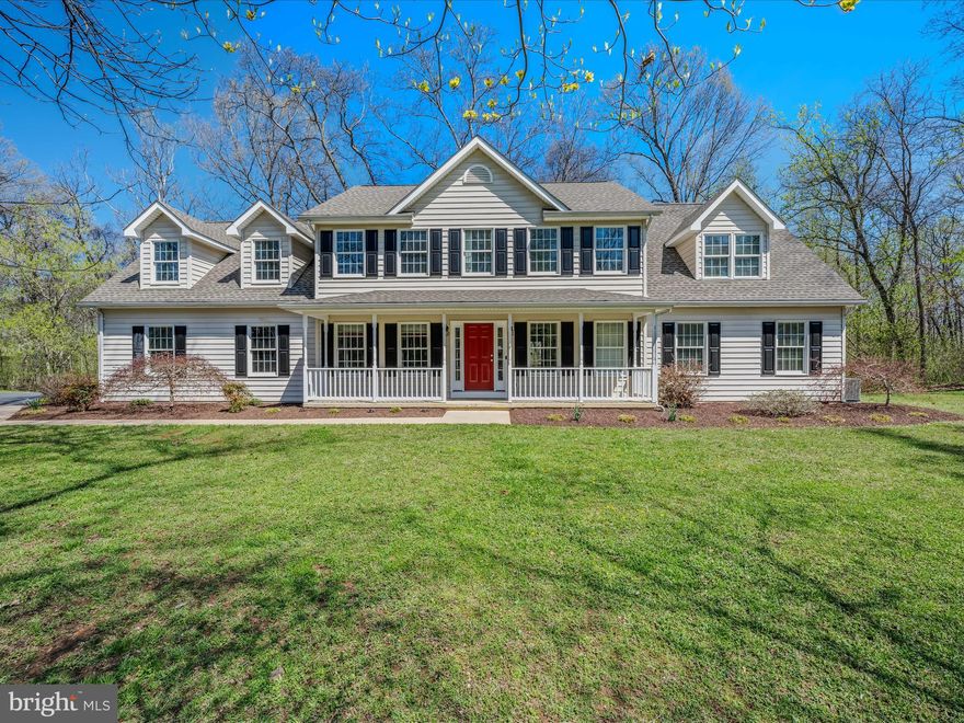 Welcome home to this spacious and versatile 5-bedroom property, ideally nestled in a serene, partially wooded setting just minutes from historic Shepherdstown. Located in a quiet, smaller subdivision near Morgan’s Grove Park, this exceptional home offers the perfect blend of privacy, comfort, and convenience on an extraordinary 3.25 acre lot.

The main level features a desirable primary suite with ample closet space and en suite bath with a soaking tub and separate walk-in shower, offering true main-floor living. The heart of the home centers around a stunning stone fireplace in the living room—perfect for cozy evenings. You'll also find a sizable, practical mudroom entry, a large attached garage, and multiple options for storage throughout the home.

Upstairs, the oversized bedrooms offer incredible flexibility—perfect for additional bedrooms, recreational space, hobby rooms, or gathering areas. Whether you need space for a growing household or you simply desire room to spread out, this home has it all.

Enjoy your morning coffee while relaxing on the front porch, while admiring the beautifully landscaped front yard and watching the abundant wildlife frolicking in your yard.  The rear deck overlooks the extensive partially fenced backyard and offers a perfect spot for entertaining, complete with a fire pit area for evenings under the stars. The large storage shed adjacent to the driveway, perfectly complements the design of the home and allows for additional space for the avid gardener, outdoor enthusiast or collector of any variety.

Just minutes away, Morgan’s Grove Park offers walking trails, a well-equipped playground, a variety of sports fields, a large picnic pavilion and more. All this while being only a short drive from Shepherdstown’s unique shops, restaurants, and cultural charm. Don’t miss the opportunity to make this peaceful retreat your new home!