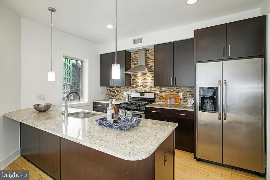 Luxury  24 foot wide, 4 bedroom, 3.5 bathroom townhome  in the heart of Northern Liberties WITH PARKING (ONLY one in the development with a garage)! As you step into the this gorgeous home that runs street to street, you'll notice the open concept main floor with an abundance of natural light from the large picture windows. The bright and inviting space has separate living and dining areas providing ample space to gather with family and friends. The gourmet kitchen is well-appointed with granite countertops, tile backsplash, European cabinetry and stainless steel appliances. There are three graciously sized bedrooms, two stylish full bathrooms, plus a laundry room with additional storage and full sized, front loading washer and dryer. The third floor master is an owner's dream! Spacious and sun-drenched with huge walk-in closets and a spa-like bath featuring a walk in, glass shower with dual shower heads. Head downstairs to the large finished basement with tons of space for entertaining! Enjoy hardwood floors and tile throughout. Bonus features include a built in security system and reserved off street parking. Conveniently located to Septa, area restaurants and attractions. All square footage numbers are approximate and include above and below grade measurements. Square footage and taxes are responsibility of the buyer to verify.