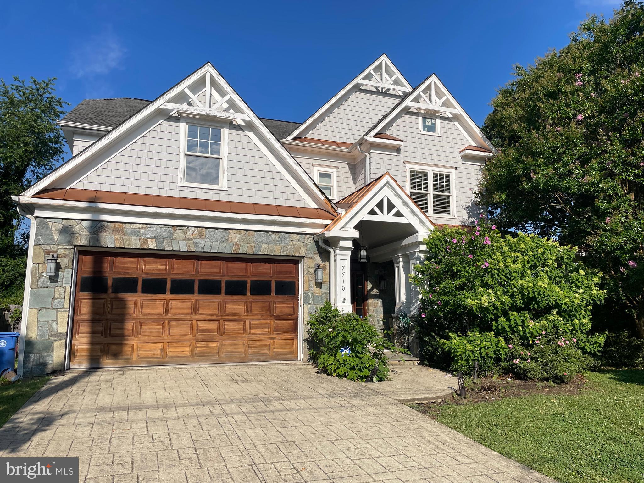 This beautifully designed Modern Craftsman-style Colonial sits on a generous corner lot in one of Bethesda’s most desirable neighborhoods. Featuring distinctive architectural elements such as cedar shake siding, copper roof accents, a stone façade, and decorative gables, this home blends timeless elegance with modern comfort.
Located within walking distance of Landon School, Pyle Middle School, and Whitman High School, and just steps from Whittier Woods Park, the home offers over 6 bedrooms and 5.5 bathrooms across four spacious levels—all with high ceilings and abundant natural light.
The main level features a formal living room with inlaid hardwood flooring, a spacious dining room with wainscoting, a bright home office, and a gourmet kitchen with cherry cabinetry, high-end stainless steel appliances, a large island (seats 4), and pantry storage. The kitchen opens to a breakfast area and great room with gas fireplace and access to a rear deck—perfect for entertaining.
Upper level includes a spacious primary suite with Juliet balcony, dual walk-in closets, and spa bath with double vanities, steam shower, and soaking tub. Three additional bedrooms, two full baths (including one Jack & Jill), and a full laundry room complete the second floor. The top level includes two large bedrooms, a full bath, and flex space. The walk-out lower level features a large rec room with gas fireplace, tiered media room, two bonus rooms, full bath, a wine cellar, and utility room.
The exterior of the home is adorned with a wraparound flagstone porch, cedar shake exterior, copper awnings, and a two-car garage. The home is cooled by an efficient two-zone HVAC system. Pets will be considered on a case-by-case basis for $50/month per pet. Long-term lease (2+ years) are preferred. Note: Photos are being temporarily withheld at the tenant’s request during move-out.