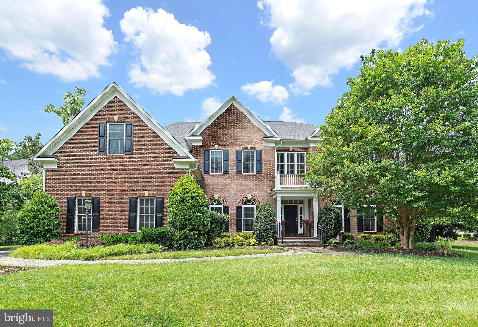 This elegant brick home with 3-car side entry garage is a former Winchester model home in sought after Riverwood community. This grand home has over 8000 square feet of finished living space. Home offers gorgeous curb appeal with triple gables, hip roof, mature landscaping, slate sidewalks and patio. Luxurious designer touches throughout with custom molding, framing accents, and decor. Exquisite living room and formal dining room greets you upon entry off the foyer with soaring ceilings. Butler's pantry with wet bar, between stately dining room with tray ceiling and kitchen makes for easy formal entertaining. Sit back and relax in your expansive great room with a wall of windows to picturesque views of the yard and a cozy fireplace for cooler evenings. Back staircase leads to an amazing overview of the great room and outside. This gourmet kitchen has all stainless Viking appliances, custom backsplash, granite counters, cherry cabinetry, huge white maple center island, spice cabinet, excellent lighting, ginormous walk-in pantry, and ample counter space. Viking double ovens and 5 burner gas cooktop, as well as a Viking microwave tucked away in the spacious island is sure to bring out your inner chef to create your favorite recipes. Private main level office with double glass door entry, built in cabinetry, and bay window will make working from home and home schooling so much easier. Powder room is adjacent to office and there is gleaming wood flooring on most of main level. The mud room area off garage with cabinets, and desk area will keep your space organized! All the bedrooms on the upper level feature walk-in closets and en suite full bathrooms. How perfect is that? No squabbling in the morning over bathrooms. The primary bedroom features sitting area bump-out, tray ceiling in bedroom area, luxury bath with jetted tub and walk-in shower, and 3 walk-in closets with custom storage. Two of the other bedrooms have custom closets and built-in shelving, and even a window seat in one. The lower level is finished to perfection with gym, media room, rec room, custom bar, full bath, 5th bedroom, and storage areas. This is the perfect gathering place for game night with family and friends or to just relax and enjoy a movie. The wet bar features, wine cooler, cherry cabinets, granite counters, wine rack, display cabinets, Viking dishwasher, and pendant lighting. Work out like a pro with professional gym flooring and mirrored walls. Huge rec room has space for pool table and built-in cabinetry for TV. The game room is a great hang out area with brick accent wall. Imagine yourself sipping your glass of wine and watch the sun set from your deck or slate patio. Huge well landscaped lot features a fun sport court to play some of your favorite outdoor games. There are so many things to tell you about this home. The foyer light will lower with remote for easy cleaning, there is a custom well treatment system, central vacuuming system, 400 amp electrical service, gas heat, painted garage flooring and 3 garage door openers, whole house sound system, and much more. Come in, relax, and explore for yourself!