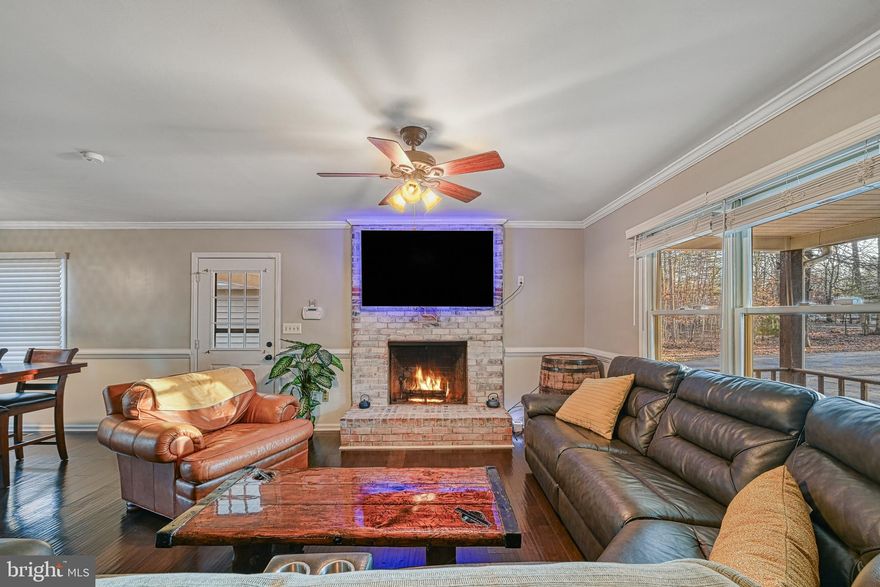 Discover exceptional versatility and true Lake living on the public side of Lake Anna. This spacious 5-bedroom, 3-bath home offers the perfect blend of comfort, functionality, and investment potential. The main level welcomes you with an open, light-filled layout featuring generous living spaces, a well-appointed kitchen, and a cozy fireplace perfect for both everyday living and entertaining. The fully finished lower level serves as a complete second living quarters with its own full kitchen, living room, two bedrooms, full bath, and private washer/dryer with a separate entrance, this space can seamlessly function as an in-law suite, guest retreat, or rental unit. Live upstairs and rent the lower level, rent both, or keep it all for personal use, the possibilities are endless.  Enjoy access to the lake with your assigned boat slip #C14, making lake days and boating a breeze. The large heated detached garage provides ample space for jet skis, lake toys, equipment, or a workshop. The peaceful, wooded lot offers plenty of room for outdoor gatherings, grilling, firepits, and soaking in the beautiful seasonal scenery. 
With two fireplaces, spacious indoor and outdoor living areas, and endless possibilities for personal use or rental income, this property is truly a rare find.