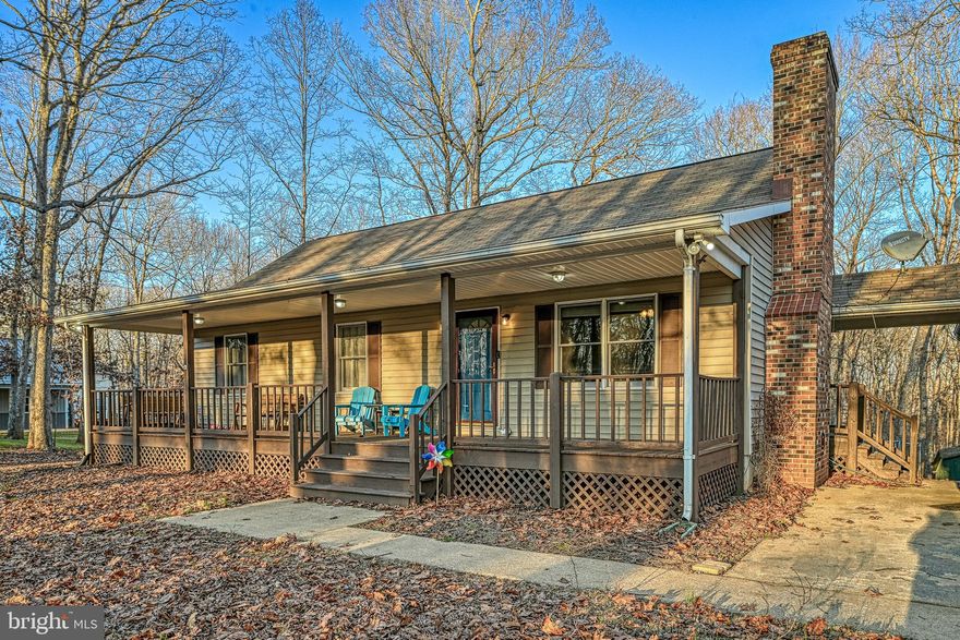 Discover exceptional versatility and true Lake living on the public side of Lake Anna. This spacious 5-bedroom, 3-bath home offers the perfect blend of comfort, functionality, and investment potential. The main level welcomes you with an open, light-filled layout featuring generous living spaces, a well-appointed kitchen, and a cozy fireplace perfect for both everyday living and entertaining. The fully finished lower level serves as a complete second living quarters with its own full kitchen, living room, two bedrooms, full bath, and private washer/dryer with a separate entrance, this space can seamlessly function as an in-law suite, guest retreat, or rental unit. Live upstairs and rent the lower level, rent both, or keep it all for personal use, the possibilities are endless.  Enjoy access to the lake with your assigned boat slip #C14, making lake days and boating a breeze. The large heated detached garage provides ample space for jet skis, lake toys, equipment, or a workshop. The peaceful, wooded lot offers plenty of room for outdoor gatherings, grilling, firepits, and soaking in the beautiful seasonal scenery. 
With two fireplaces, spacious indoor and outdoor living areas, and endless possibilities for personal use or rental income, this property is truly a rare find.