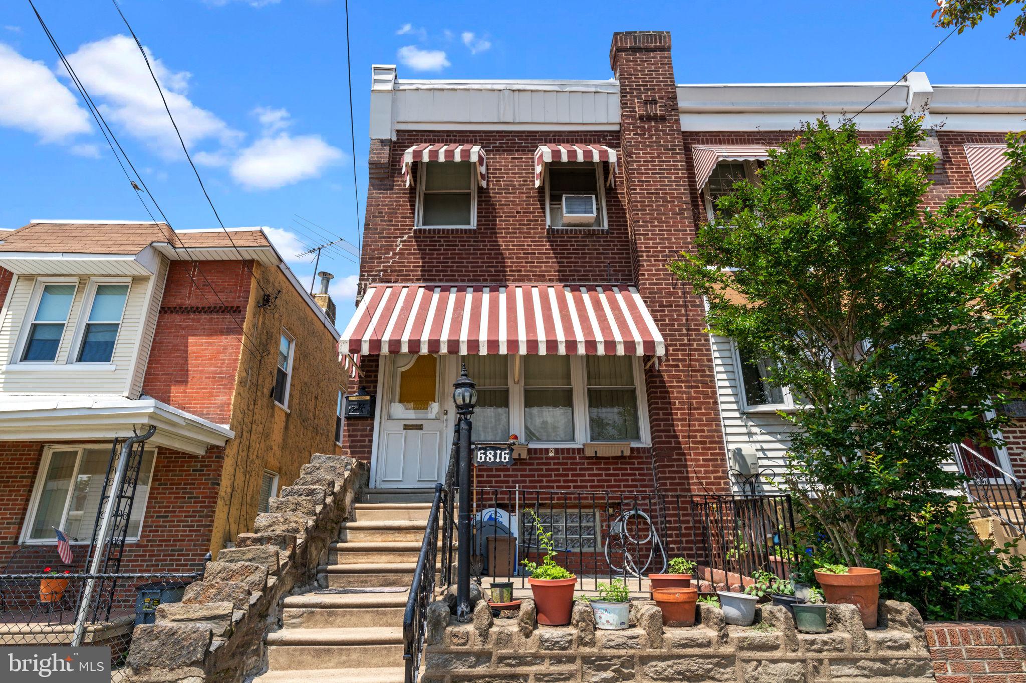 Welcome to this beautifully maintained end-of-row home located in the sought-after Disston Estate section of Tacony. This unique property offers a blend of classic character and modern convenience you won’t find elsewhere in the neighborhood.
Step onto the inviting front patio, accented by a striking stone retaining wall—perfect for morning coffee or evening relaxation. Inside, a heated and enclosed porch with tile flooring and a ceiling fan welcomes you into a sun-filled living room featuring gleaming hardwood floors and a large picture window. The formal dining room is ideal for entertaining, and the adjacent galley-style kitchen provides ample cabinetry and countertop space for all your culinary needs.
Upstairs, you'll find three generously sized bedrooms, each with ceiling fans and ample closet space. A full ceramic tile bathroom offers a soaking tub/shower combo, vanity, and toilet. The full, expanded basement provides tons of potential—finish it to create a home office, gym, or additional living space. It also includes a laundry area with washer and dryer (included), a separate storage room, and a convenient toilet. Walk out to the rear driveway offering off-street parking and an awesome setup for outdoor entertaining.
The lot extends 100 feet in depth and includes a fully fenced rear garden area beyond the shared driveway. Additional highlights include vinyl replacement windows throughout, updated electric, and thoughtful details throughout the home.
Conveniently located near the Delaware River, Tacony-Palmyra Bridge, I-95, public transit, shopping, and dining—this home is truly a must-see!