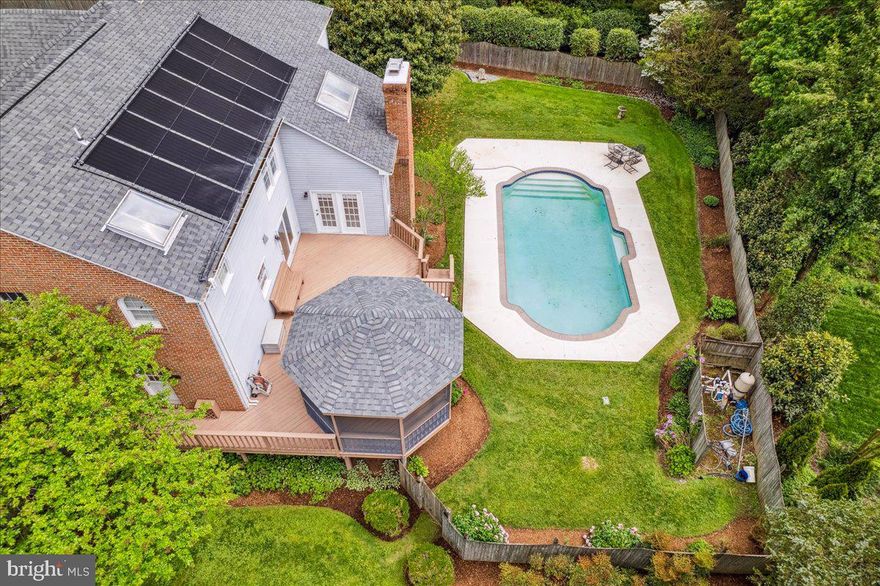 A gorgeous colonial home on 1.3 acres hits the market in sought-after Oakton, VA! From the moment you arrive, the stately curb appeal and professionally designed landscape set the tone for what’s inside. The main level welcomes you with a classic layout infused with warmth and style, featuring formal living and dining rooms, a library, and an inviting family room with vaulted ceilings, skylights, and a wood-burning fireplace. The gourmet kitchen has stainless steel appliances, a designer backsplash, a granite island with seating and a built-in desk, and custom cabinetry—a perfect space for culinary creativity and entertaining. Upstairs, the luxurious primary suite offers a quiet retreat with a spacious sitting room and a bath featuring a soaking tub, separate shower, and elegant ceramic finishes. Three additional generously-sized bedrooms and two full bathrooms complete the upper level. The finished, lower-level walk-out expands the living space with a second wood-burning fireplace, a full bedroom and bath, a small bar area, and abundant storage—ideal for guests, recreation, or multi-generational living. Step outside to your private backyard oasis: a large deck, screened-in gazebo, and a sparkling, solar-heated, in-ground pool surrounded by lush landscaping create the perfect setting for outdoor gatherings or peaceful solitude. Ideally located in the sought-after Fairfax County School District, this home is zoned for Waples Mill Elementary, Franklin Middle, and Oakton High School. This home also offers peace of mind with recent upgrades, including a new roof and AC in 2019, a new water heater in 2021, and a beautifully remodeled kitchen in 2013.