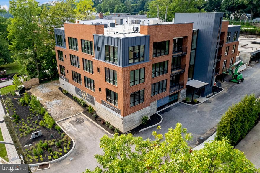 Wayne 427 is a brand new boutique residential condominium. The striking design and meticulous craftsmanship create a modern, industrial presence in a well-established neighborhood. Situated in a scenic setting, Wayne 427 is comprised of 2 condo buildings with 11 homes in each and only 4 units per floor. Here you will find high-end finishes and amenities, along with utmost convenience and security in Wayne's most upscale condo community. Every home is a corner unit positioned to optimize natural light and views through the floor-to-ceiling windows. This unit has 3 bedrooms, 2 baths, 1 powder room, and is the result of thoughtful design, with private covered terraces for outdoor enjoyment. A gracious entry foyer welcomes you and offers a seamless flow for entertaining, with a stunning sun-bathed great room that incorporates open living, dining and kitchen areas. Airy 9+ ceilings, custom millwork, hardwood and carpeted floors, a custom fireplace, solid core interior doors with designer hardware, detailed recessed & decorative lighting, generous closet space, and a laundry room are among the alluring features. The gourmet kitchen is tailored to the chef with custom-designed cabinetry, sleek countertops, top-quality appliances, and a center island with seating. Bathrooms clad in tile and marble are beautifully appointed with custom cabinets and premium fixtures. The primary bath includes double sinks, soaking tub, and separate shower with frameless glass door. Bedrooms are comfortably sized and privately separated from the living space. A green roof garden & pet-friendly park centers the buildings, and lush plantings surround the perimeter lending serenity and privacy. Dramatic main entryways boast metal clad towers enclosing the stairs and vertical glass walls filtering light into the lobbies and corridors at each level. Custom-fitted elevators, keyless entry, an underground parking garage, energy-efficient systems, individual storage lockers for each residence, a well-equipped gym, meeting room, mail/package room, 24/7 emergency maintenance plus landscaping and snow removal services enhance the low-maintenance luxury lifestyle. Perfectly situated on desirable Lancaster Ave, Wayne 427 is a short walk to historic Wayne, in the heart of the Main Line. You are just steps from shopping, dining, parks, top-rated Radnor Schools, and the train to Center City!

A Building is completely sold and settled. All available units are located in the B Building. There are no model units to show at this point. Construction has begun on B building, delivery in late summer 2023. One parking spot included in purchase price, additional parking spaces are available for purchase on a first come, first served basis. Agent must pre-register or accompany buyer on first visit.  Taxes to be determined after sale. 

This Unit will come with the Upgrade kitchen appliance package (Thermador), plus wine fridge.  The larger island with base cabinets and countertops is also included.